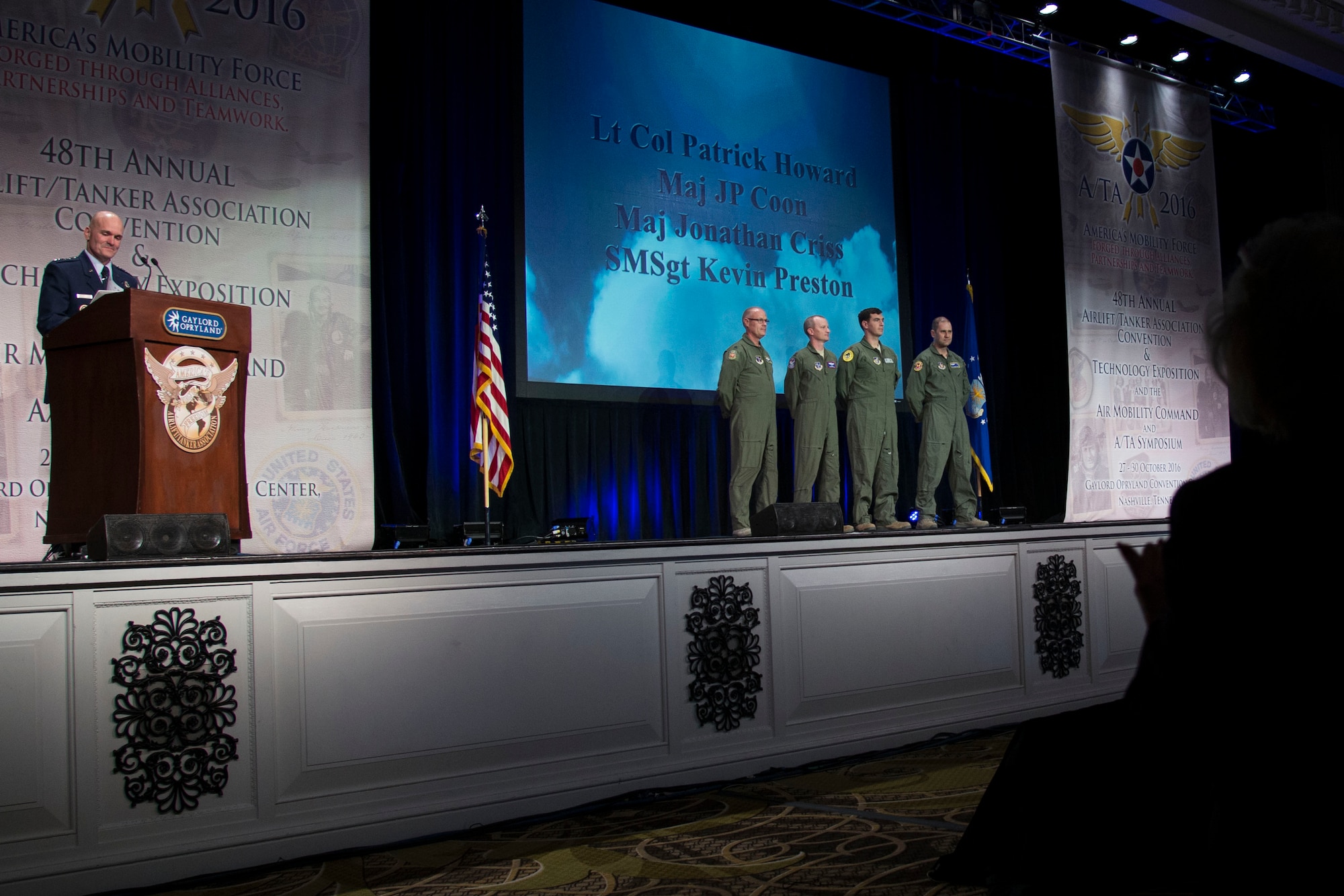 Gen. Carlton D. Everhart II, the Air Mobility Command commander, recognizes four individuals from an aeromedical evacuation team during the 48th Air Mobility Command and Airlift/Tanker Association Symposium in Nashville, Tennessee, Oct. 29, 2016. In 2010, the team transported a U.S. Marine Sergeant from Afghanistan to the U.S. to receive medical care after he suffered injuries from an improvised explosive device while on patrol. (U.S. Air Force photo by Airman 1st Class Melissa Estevez)