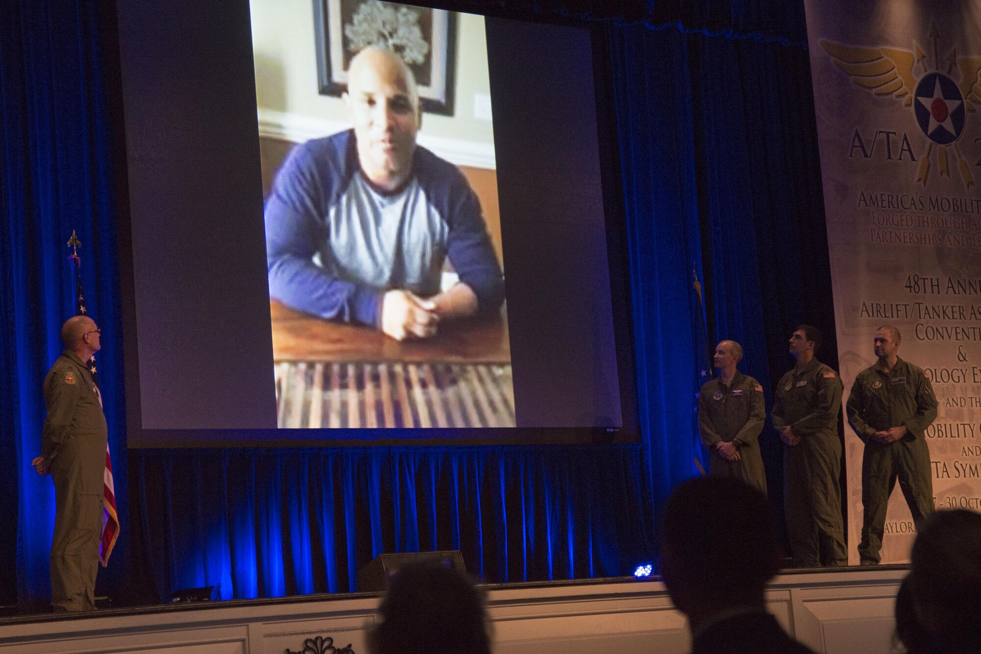 Retired Marine Sergeant Carlos Evans thanks the aeromedical evacuation team during the 48th Air Mobility Command and Airlift/Tanker Association Symposium in Nashville, Tennessee, Oct. 29, 2016. In 2010, the Airmen transported Evans from Afghanistan to the U.S. on a C-17 to receive medical care after he suffered injuries from an improvised explosive device while on patrol. Evans was unconscious from the time he stepped on the IED in Afghanistan until he woke up at Walter Reed Medical Center in Bethesda, Maryland. During his keynote address, Everhart provided Evans his first opportunity to put faces and names to the aeromedical evacuation team who helped him. (U.S. Air Force photo by Airman 1st Class Melissa Estevez) 