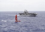 " Sailors aboard a rigid-hull inflatable boat, launched from the amphibious assault ship USS Makin Island (LHD 8), approach the trimaran of a missing Chinese mariner during a search and rescue mission in the western Pacific Ocean. The Makin Island Amphibious Ready Group is deployed with the embarked 11th Marine Expeditionary Unit in support of the Navy™s maritime strategy in the U.S. 3rd Fleet area of responsibility.
