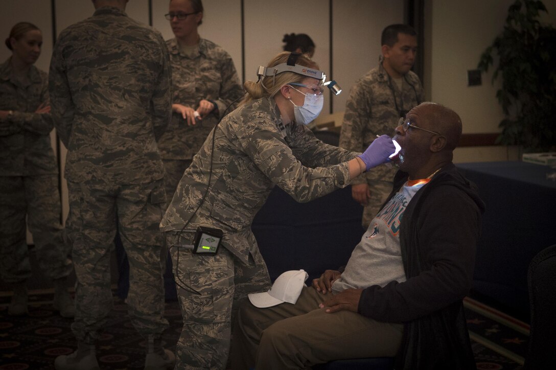Anthony Floyd, Air Force retiree, has his teeth examined during Retiree Appreciation Day on Joint Base Andrews, Md., Oct. 29, 2016. The event included a health fair and flu shots, and also gave information on Tricare, recreation activities, and more. (U.S. Air Force photo by Senior Airman Mariah Haddenham)