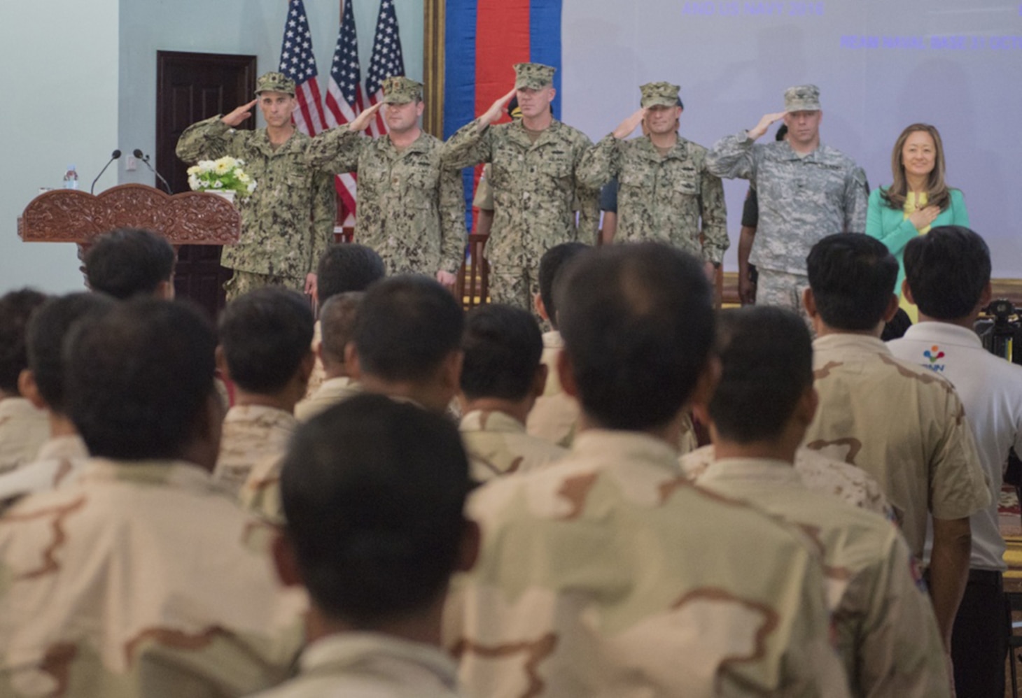 The official party render salutes during the playing of the national anthems during the opening ceremony of Cooperation Afloat Readiness and Training (CARAT) Cambodia 2016. CARAT is a series of annual maritime exercises between the U.S. Navy, U.S. Marine Corps and the armed forces of nine partner nations to include Bangladesh, Brunei, Cambodia, Indonesia, Malaysia, the Philippines, Singapore, Thailand, and Timor-Leste.