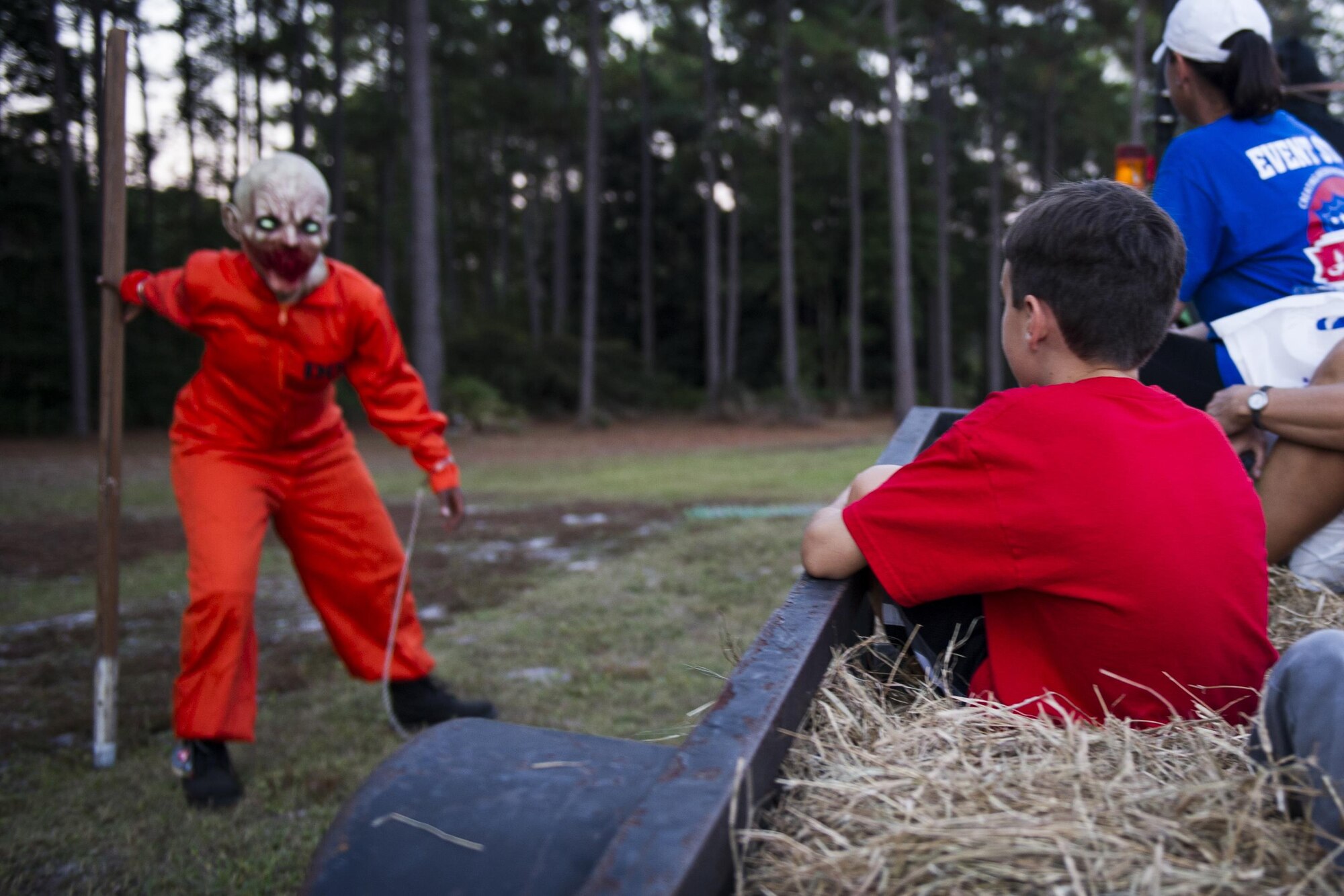 A child rides on a wagon during the haunted hay ride during the Haunted Lakes Fall Festival at Gator Lakes Golf Course on Hurlburt Field, Fla., Oct. 28, 2016. The hay ride took participants through a series of spooky displays. (U.S. Air Force photo by Airman 1st Class Joseph Pick)