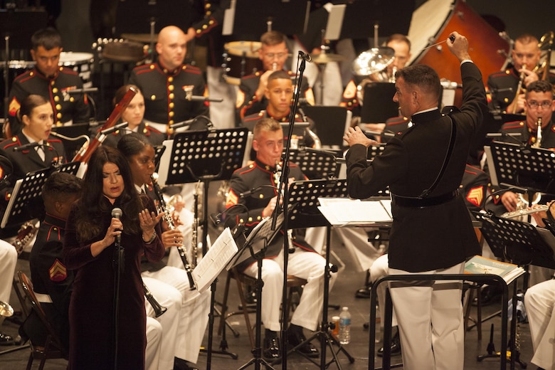 Famed Opera singer Hilda Ramos, joins members of the Marine Corps Band New Orleans at the Ponce La Perla Theater during a concert to celebrate the Marine Corps Reserve Centennial in Puerto Rico on Oct. 17, 2016. Marine Forces Reserve is commemorating 100 years of rich history, heritage, espirit-de-corps across the U.S. The Centennial celebration recognizes the Reserve's essential role as a crisis response force and expeditionary force in readiness, constantly preparing to augment the active component. (U.S. Marine photo by LCpl. Ricardo Davila/ Released)