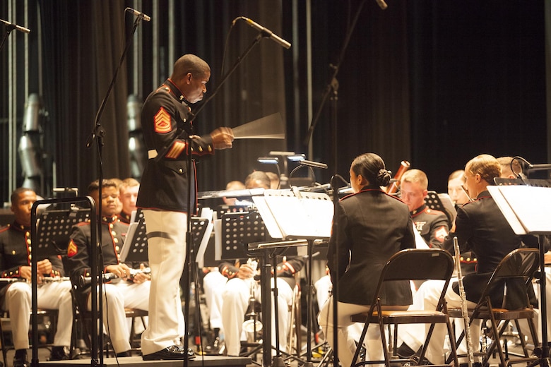 Gunnery Sgt. Justin Hauser, enlisted conductor of Marine Corps Band New Orleans, conducts the band during a concert to celebrate the Marine Corps Reserve Centennial La Perla Theater in Puerto Rico on Oct. 17, 2016. Marine Forces Reserve is commemorating 100 years of rich history, heritage, espirit-de-corps across the U.S. The Centennial celebration recognizes the Reserve's essential role as a crisis response force and expeditionary force in readiness, constantly preparing to augment the active component. (U.S. Marine photo by LCpl. Ricardo Davila/ Released)