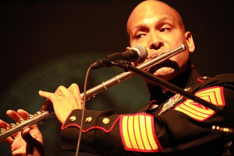 Master Sgt. Joel Cortez from Marine Corps Band New Orleans plays flute during a latin performance for the local residents and distinguished guest during the Marine Forces Reserve Centennial Celebration concert at the Centro De Bellas Artes in Humacao, Puerto Rico, Oct. 19, 2016. Marine Forces Reserve is commemorating 100 years of rich history, heritage, Espirit-de-corps across the U.S. This celebration recognizes the Reserve's essential role as a crisis response force and expeditionary force in readiness, constantly preparing to augment the active component. (U.S. Marine photo by Master Sgt. John A. Lee, II / Released)