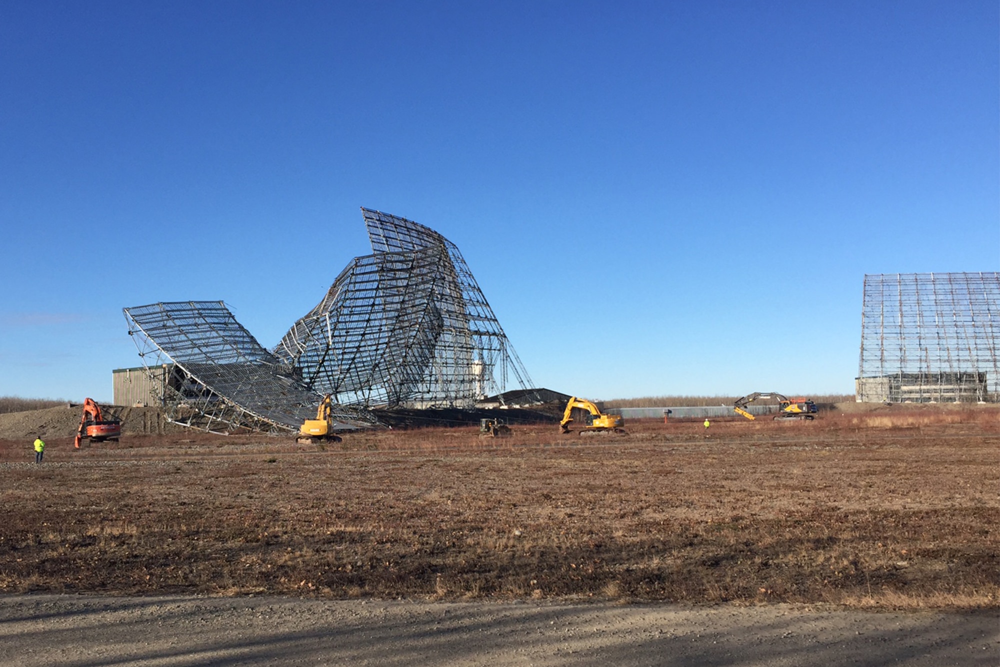 CLEAR AIR FORCE STATION, Alaska – Crews use cables and excavators to demolish the defunct Ballistic Missile Early Warning System radar at Clear Air Force Station, Alaska, Oct. 18, 2016. The radar was taken down and is being removed and recycled to make way for new construction. (Courtesy photo)