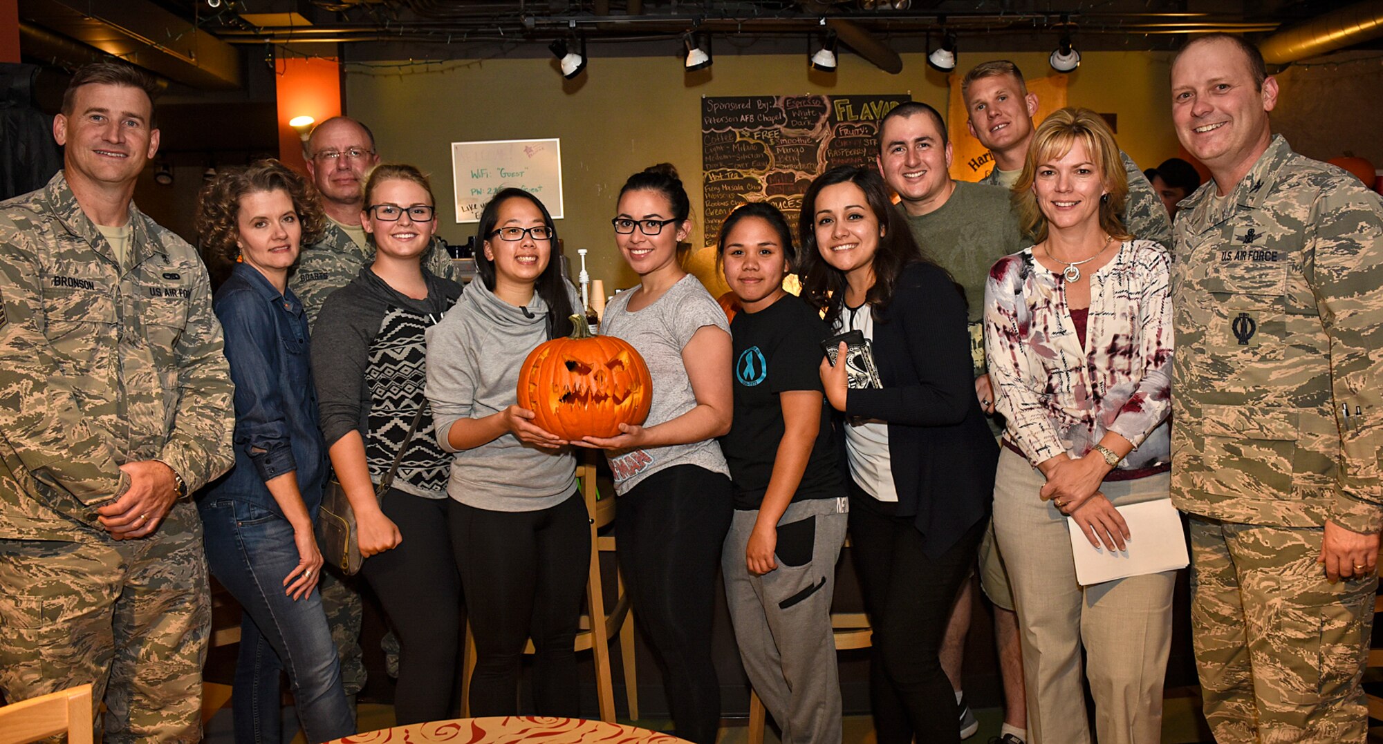 PETERSON AIR FORCE BASE, Colo. – Wing leadership congratulates the winning team at the conclusion of the base chapel’s 4th Annual Pumpkin Carving Contest held at the Eclipse Cyber Café on Peterson Air Force Base, Colo., Oct. 26, 2016. The winning team consisted of Airmen from 50th Operations Support Squadron at Schriever AFB, Colorado, 6th Space Operations Squadron at Schriever AFB, 21st Medical Operations Squadron, the 21st Security Forces Squadron and a military spouse. (U.S. Air Force photo by Senior Airman Rose Gudex)