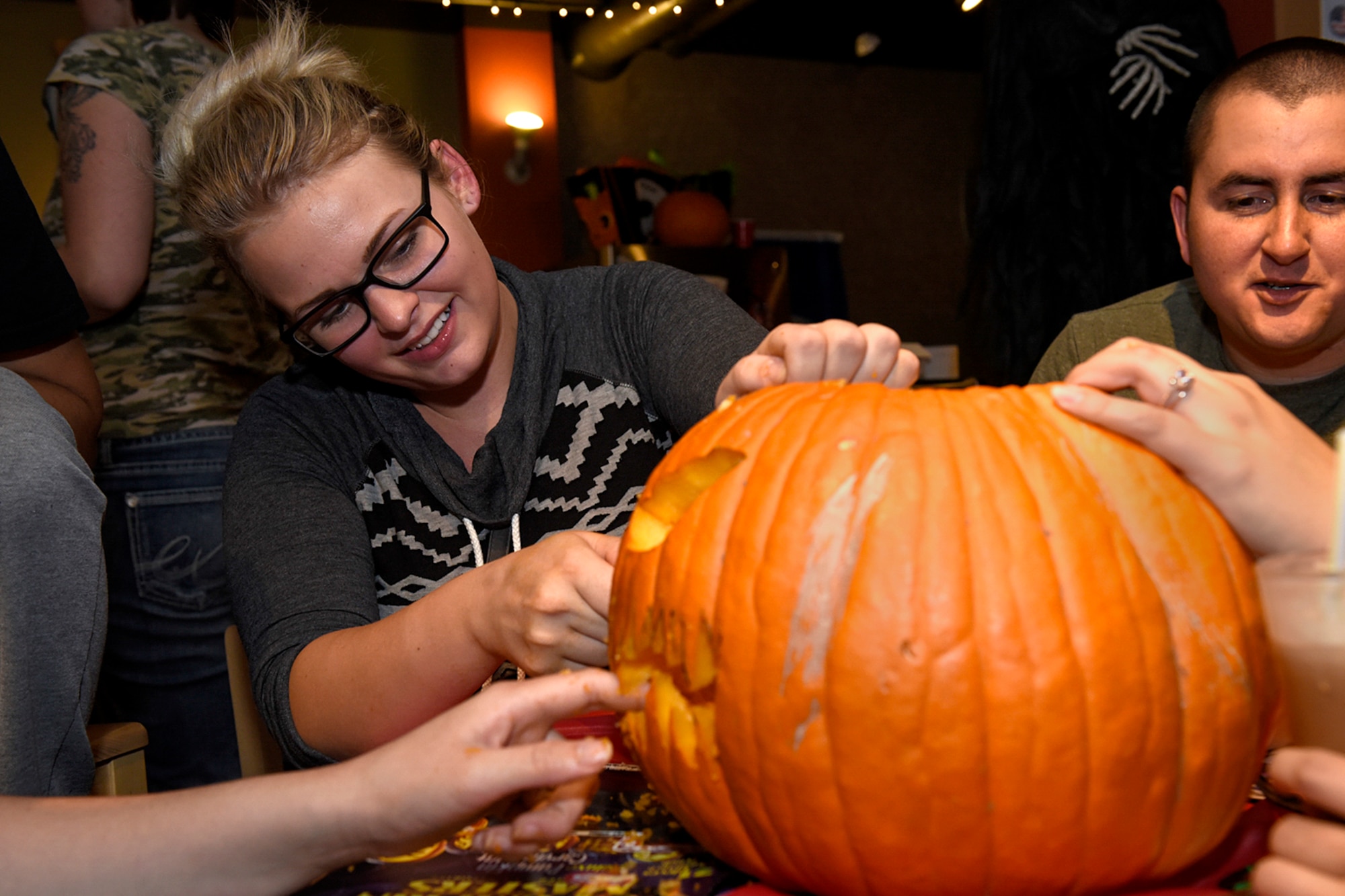 PETERSON AIR FORCE BASE, Colo. – Senior Airman Sam Krivanek, 6th Space Operations Squadron, carves a pumpkin with her team at the base chapel’s 4th Annual Pumpkin Carving Contest at the Eclipse Cyber Café on Peterson Air Force Base, Colo., Oct. 26, 2016. The event encouraged wholesome holiday fun and was hosted by the chapel. (U.S. Air Force photo by Senior Airman Rose Gudex)