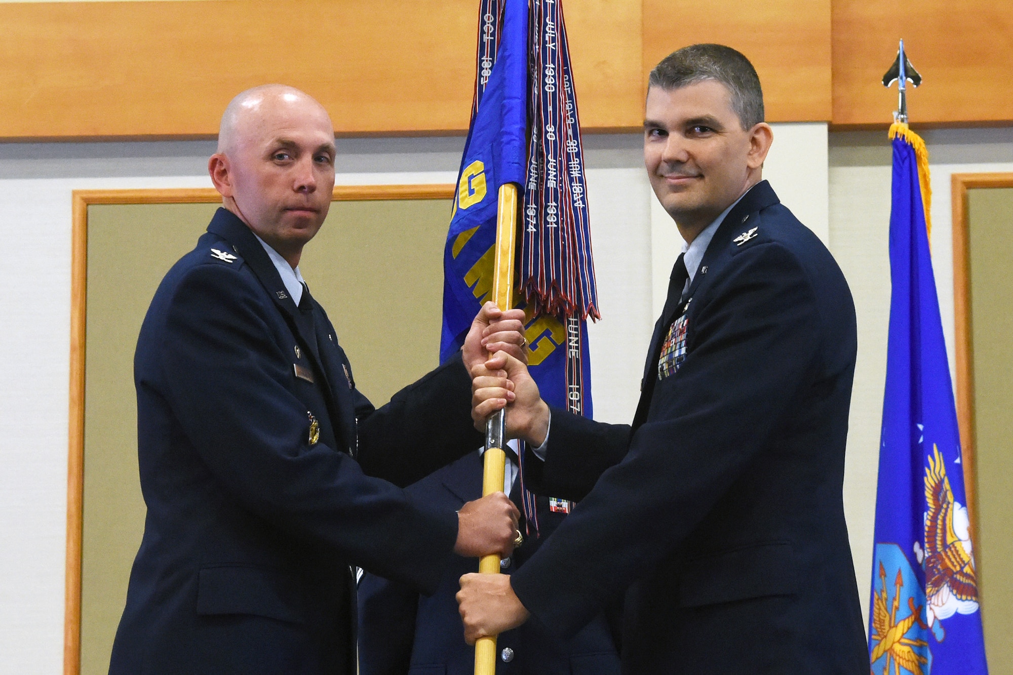 Col. Craig Forcum, right, accepts command of the 341st Medical Group from Col. Ron Allen, 341st Missile Wing commander, during a change of command ceremony at the Grizzly Bend July 7, 2016, at Malmstrom Air Force Base, Mont. Forcum arrived at Malmstrom on June 30, and took command of the 341 MDG on July 7, 2016. (U.S. Air Force photo/Senior Airman Jaeda Tookes)