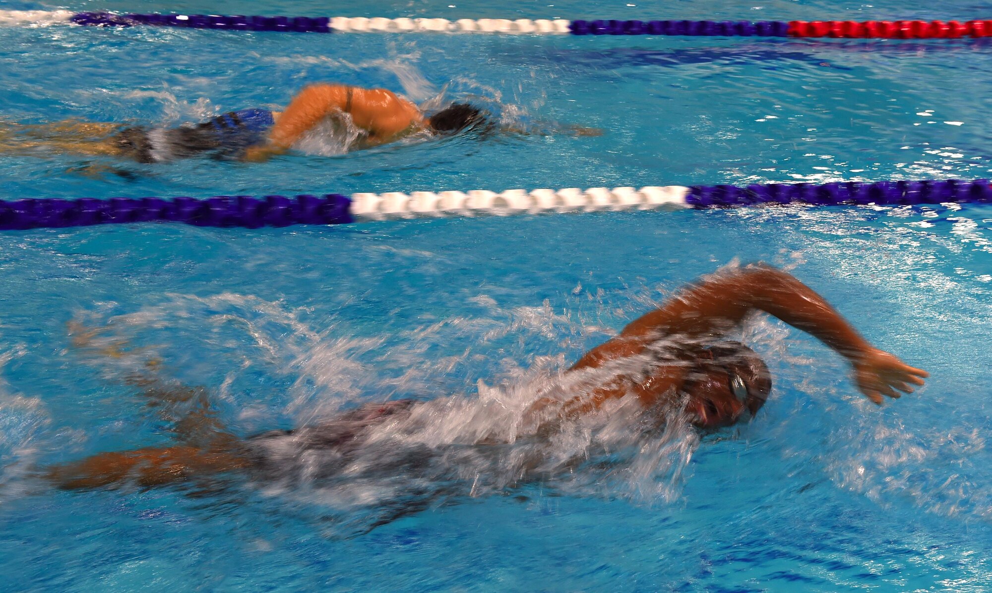 Alex Stubbs, a medical technician with the 673d Medical Operations Squadron swims past Justin Olsen, a C-17 Globemaster III loadmaster with the 249th Airlift Squadron, during the second intramural swim meet competition at Buckner Physical Fitness Center at Joint Base Elmendorf-Richardson, Alaska, Oct. 28, 2016. Thirty people participated in 28 events during the final swim meet of the year. Scores from both meets were combined to determine first, second and third place winners. 