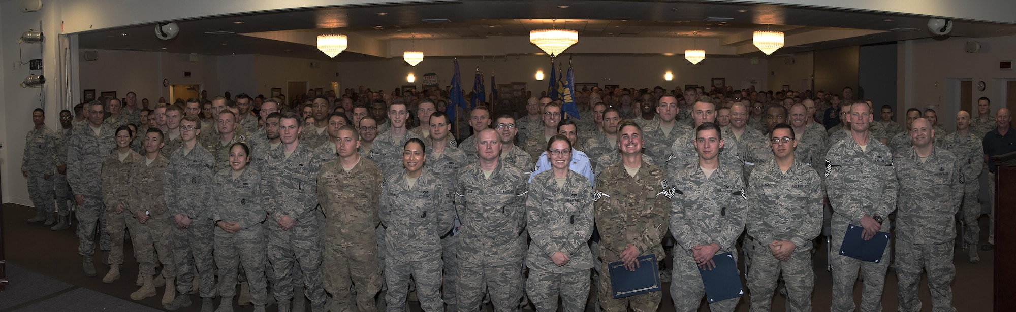 Enlisted Airmen who promoted in October pose with Col. Stephen Kravitsky, 90th Missile Wing commander, Chief Master Sgt. Jeffery Steagall, 90th MW command chief; and the assembled audience, Oct. 31, 2016, at F.E. Warren Air Force Base, Wyo. Each month the Mighty Ninety hosts a celebration for enlisted promotees from the base. (U.S. Air Force photo illustration of four photos by Senior Airman Brandon Valle)