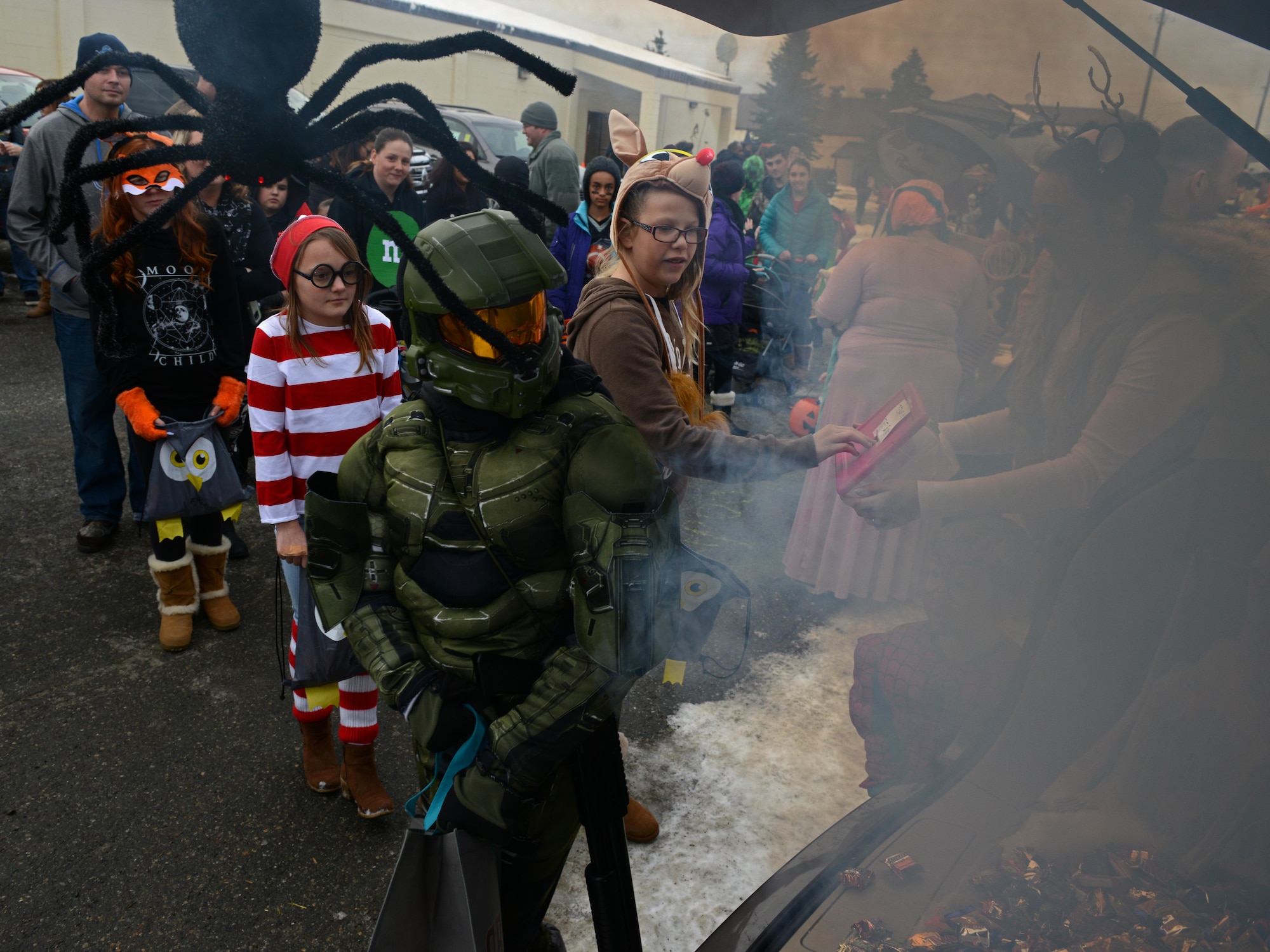 Joint Base Elmendorf-Richardson candy enthusiasts trick-or-treat during Trunk or Treat at the Arctic Oasis, Oct. 28, 2016. JBER Halloween aficionados decorated their vehicles and handed out candy during Trunk or Treat as attendees voted on the best-decorated trunk. Trick-or-treaters also participated in indoor Halloween games and activities. 