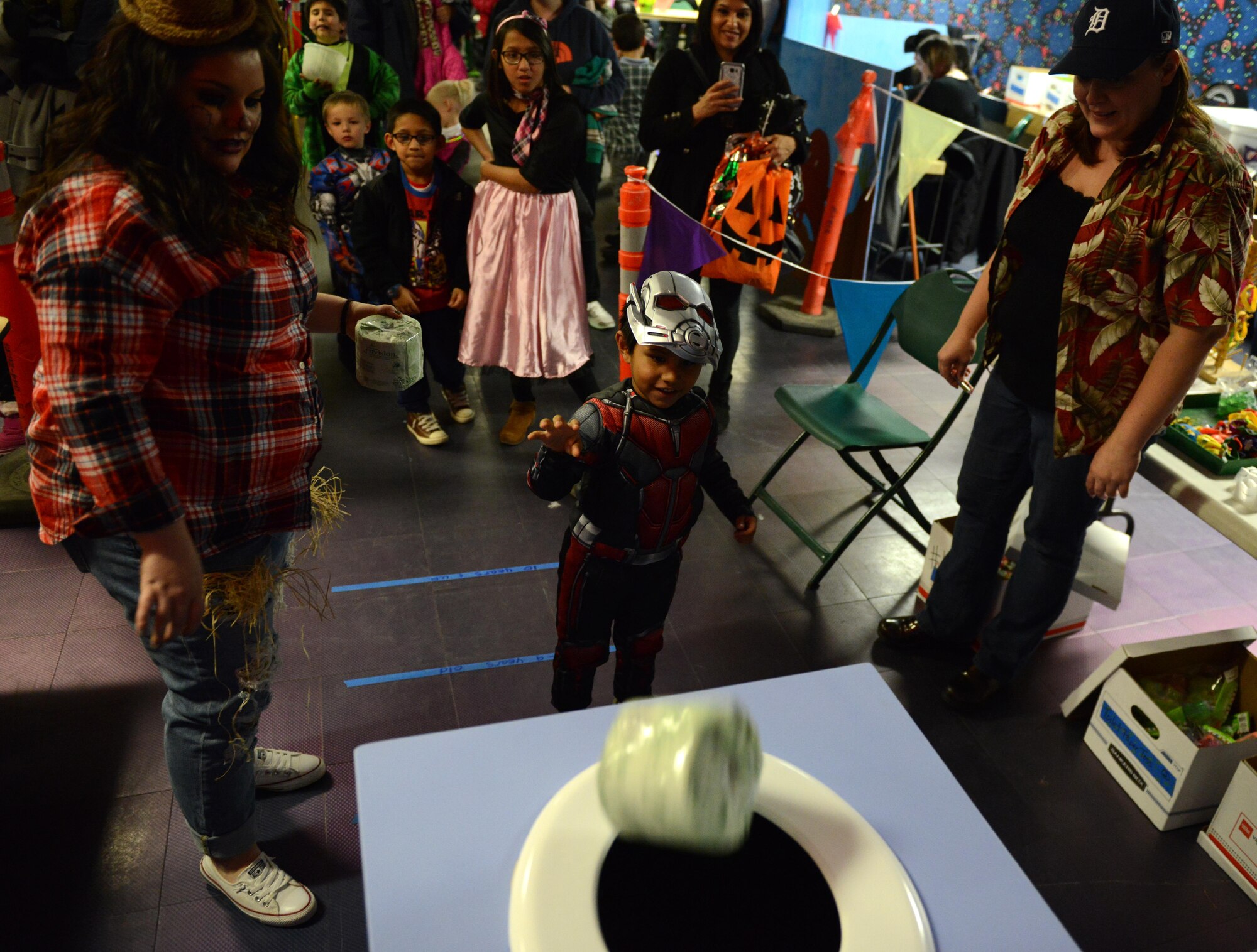 Manuel Alvarado, 4, shoots a roll of toilet paper during Trunk or Treat at the Arctic Oasis at Joint Base Elmendorf-Richardson, Alaska, Oct. 28, 2016. JBER Halloween aficionados decorated their vehicles and handed out candy during Trunk or Treat as attendees voted on the best-decorated trunk. Trick-or-treaters also participated in indoor Halloween games and activities. 