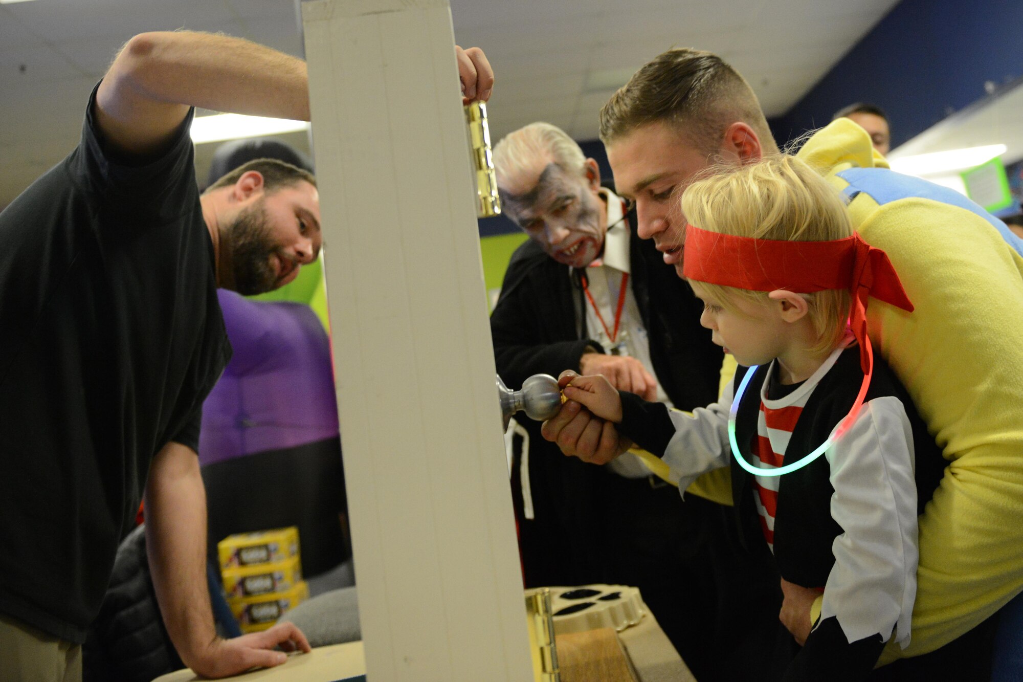 Abram Taylor, 2, and father John Paul Taylor, a gunner with the 2nd Battalion, 377th Parachute Field Artillery Regiment, try to find the “Lucky Key” and unlock a door for a prize during Trunk or Treat at the Arctic Oasis at Joint Base Elmendorf-Richardson, Alaska, Oct. 28, 2016. JBER Halloween aficionados decorated their vehicles and handed out candy during Trunk or Treat as attendees voted on the best-decorated trunk. Trick-or-treaters also participated in indoor Halloween games and activities. 
