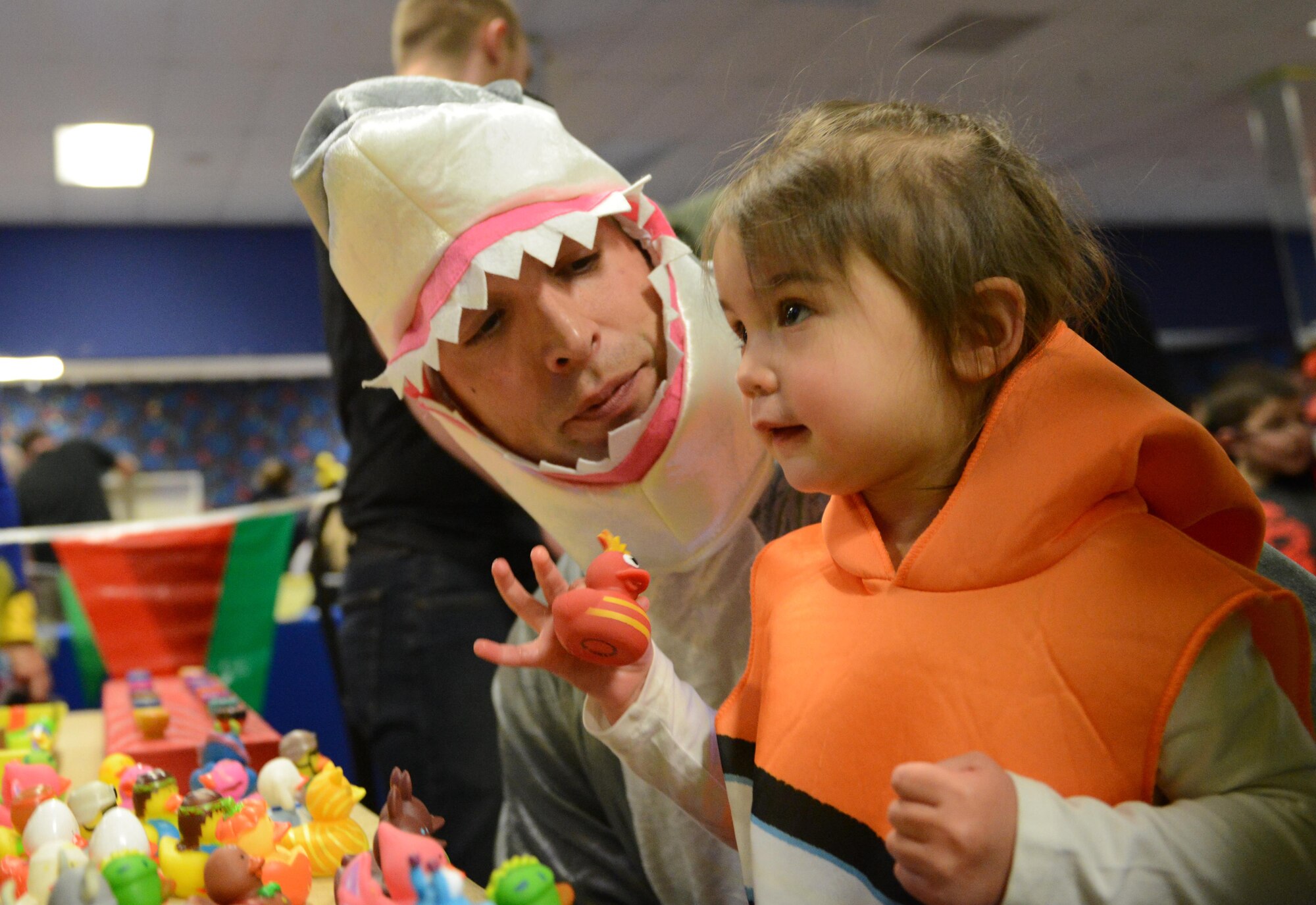 Phill Sawin, and daughter Isabelle, 2, pick their prize during Trunk or Treat event at the Arctic Oasis at Joint Base Elmendorf-Richardson, Alaska, Oct. 28, 2016. JBER Halloween aficionados decorated their vehicles and handed out candy during Trunk or Treat as attendees voted on the best-decorated trunk. Trick-or-treaters also participated in indoor Halloween games and activities. 