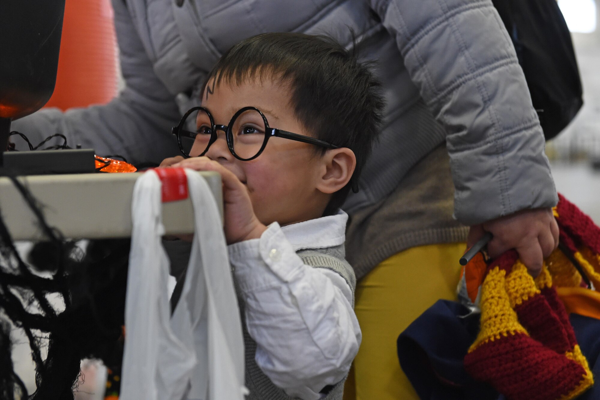 Aiden Manera, 2, checks in before the start of a costume fun run in Hangar 5 at Joint Base Elmendorf-Richardson, Alaska, Oct. 28, 2016. The run was a mile long and prizes were awarded to the top three finishers as well as best adult and child costumes. 