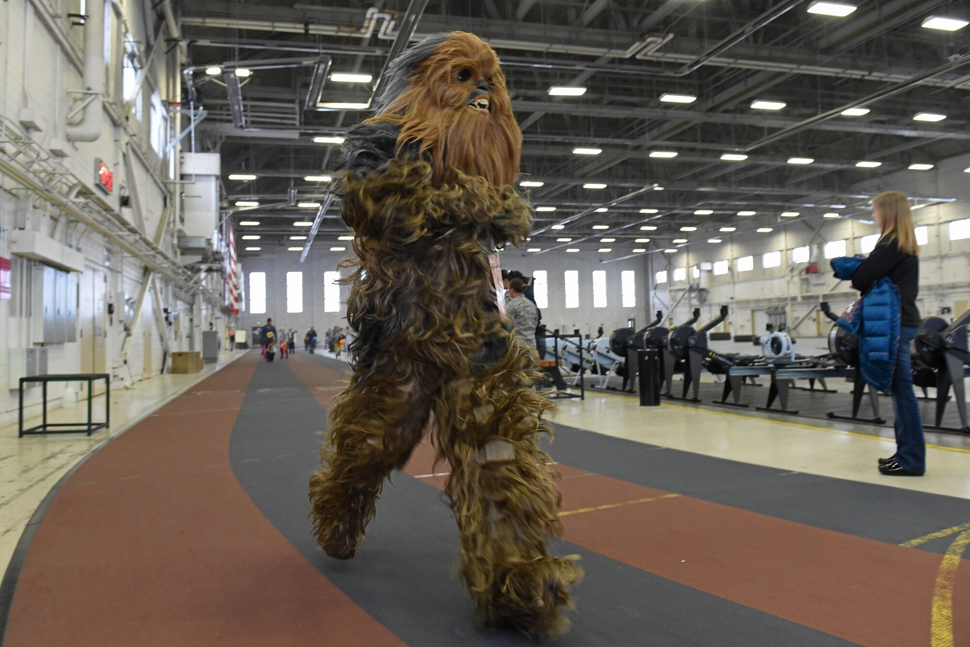 Service members and families participate in a costume fun run in Hangar 5 at Joint Base Elmendorf-Richardson, Alaska, Oct. 28, 2016. The run was a mile long and prizes were awarded to the top three finishers as well as best adult and child costumes. 