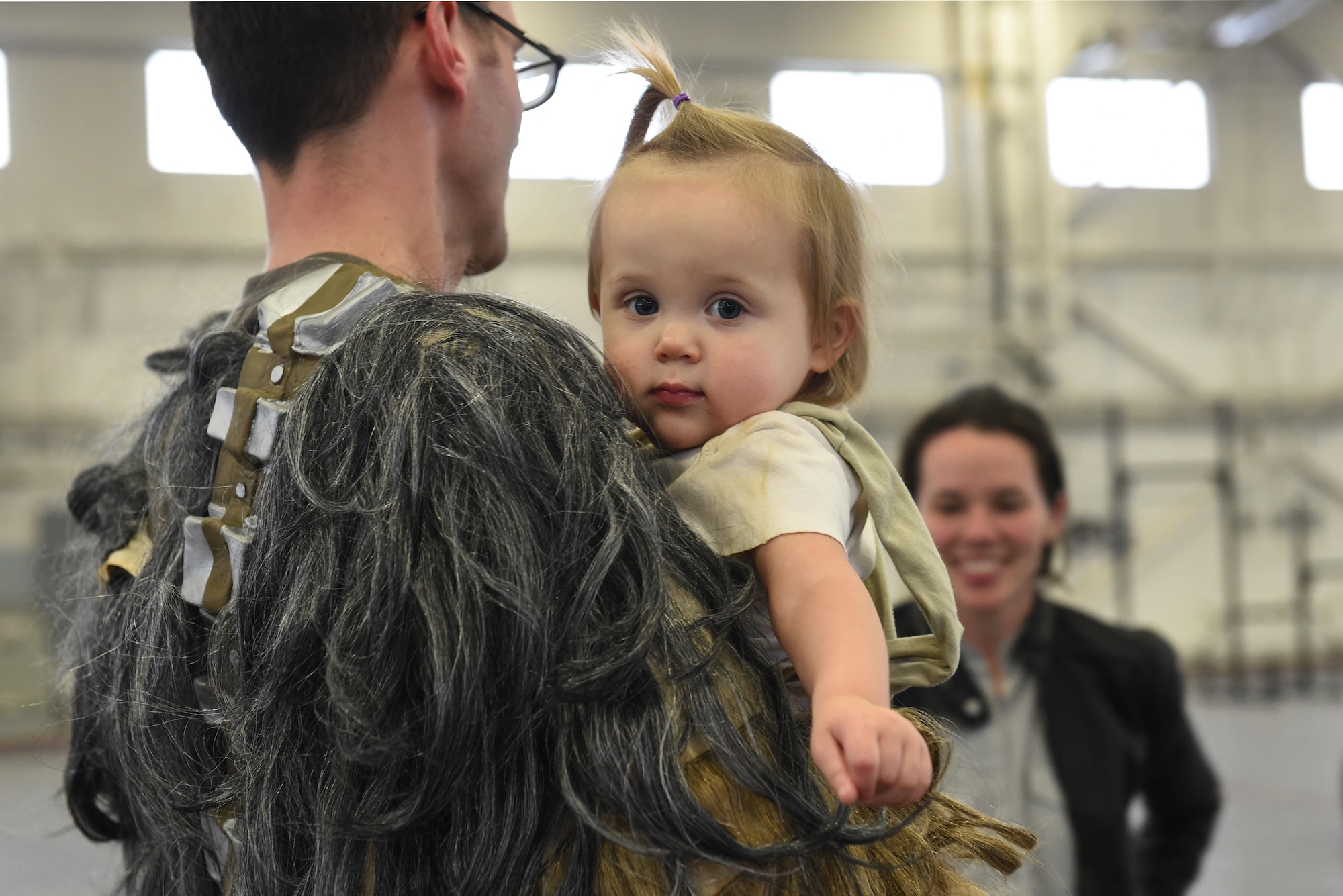 Kiera Jenky, 16 months, takes a break after a costume fun run in Hangar 5 at Joint Base Elmendorf-Richardson, Alaska, Oct. 28, 2016. The run was a mile long and prizes were awarded to the top three finishers as well as best adult and child costumes. 