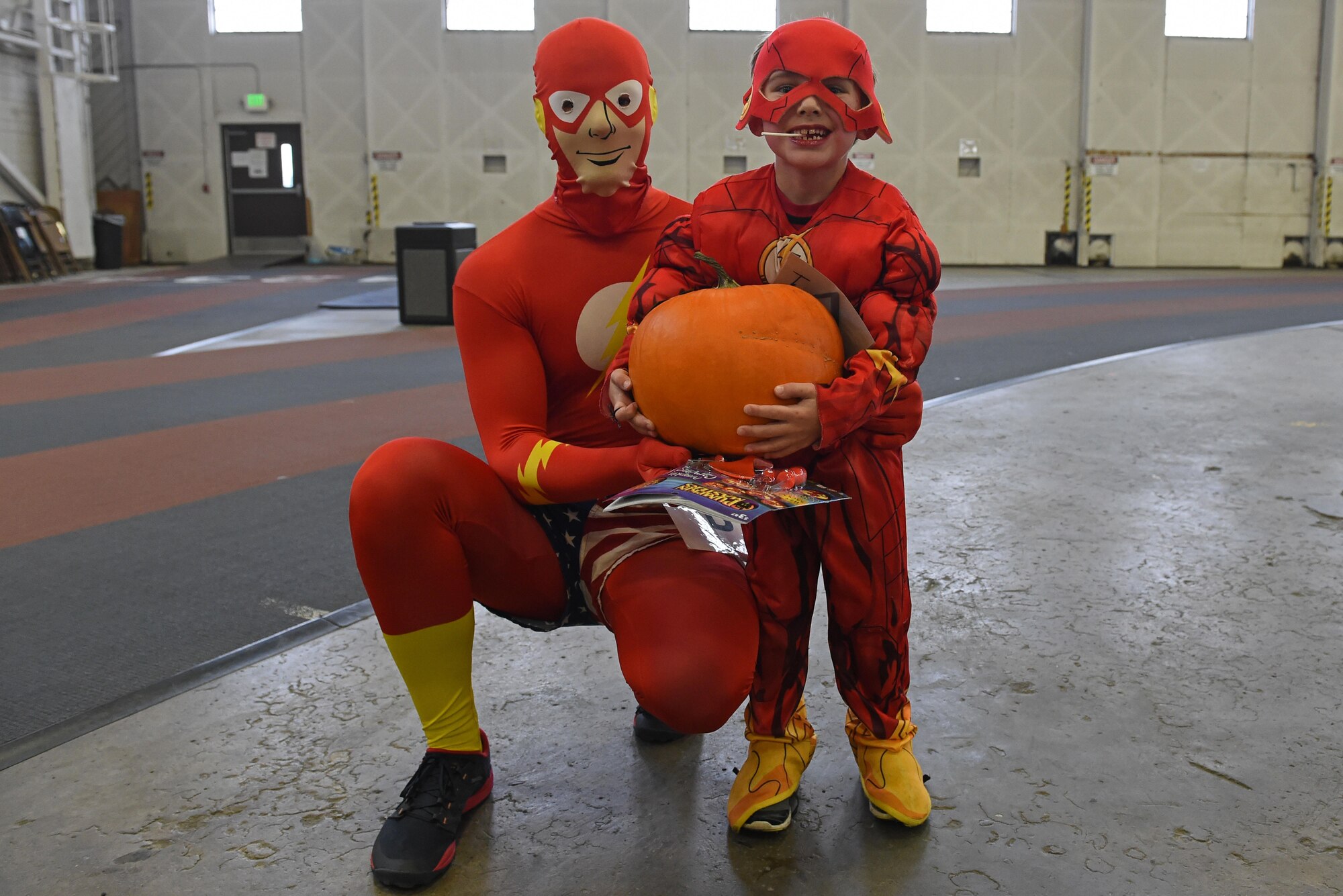 Dawson Cornell, 6, receives a pumpkin during a costume fun run in Hangar 5 at Joint Base Elmendorf-Richardson, Alaska, Oct. 28, 2016. The run was a mile long and prizes were awarded to the top three finishers as well as best adult and child costumes. 