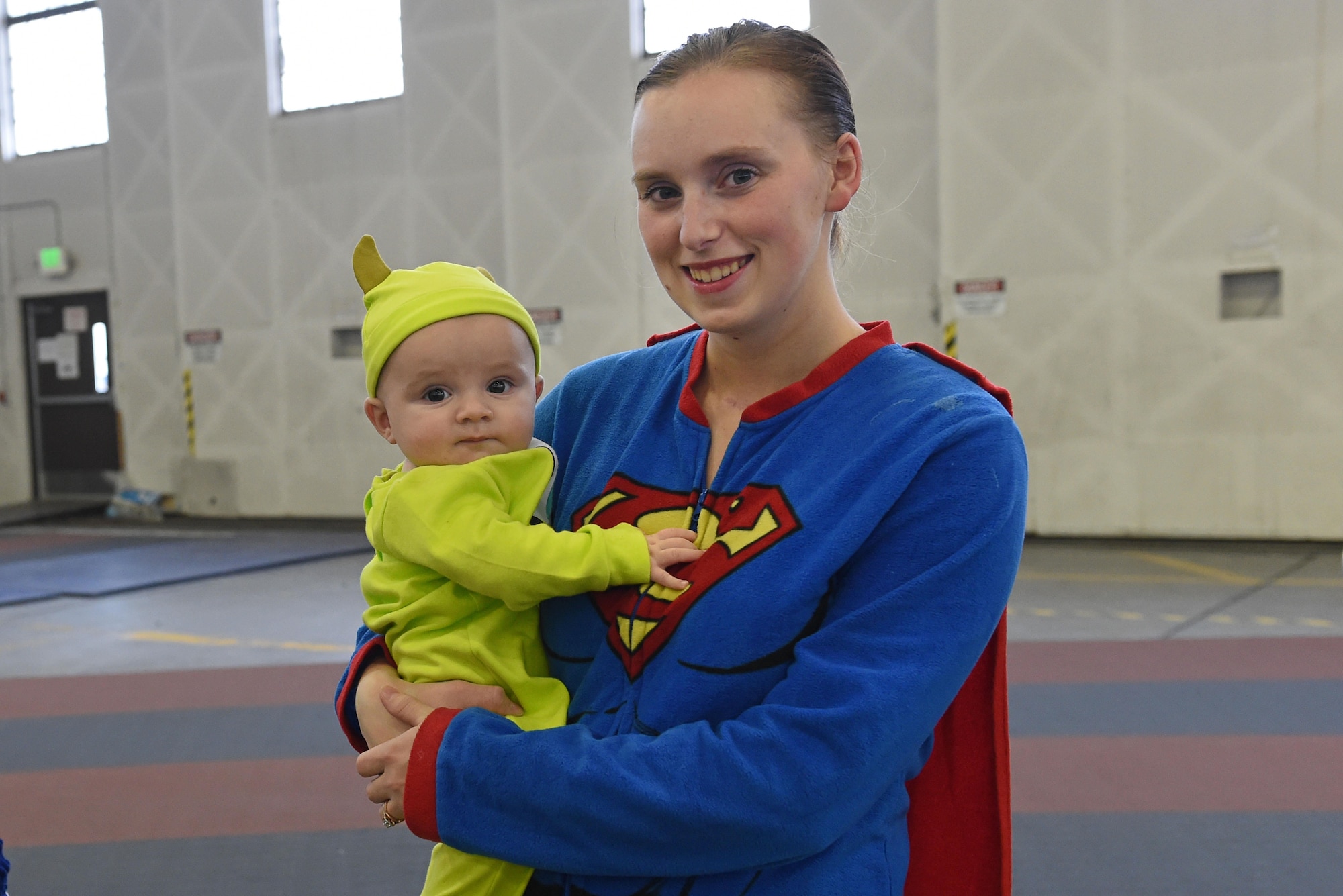 Service members and families participate in a costume fun run in Hangar 5 at Joint Base Elmendorf-Richardson, Alaska, Oct. 28, 2016. The run was a mile long and prizes were awarded to the top three finishers as well as best adult and child costumes. 