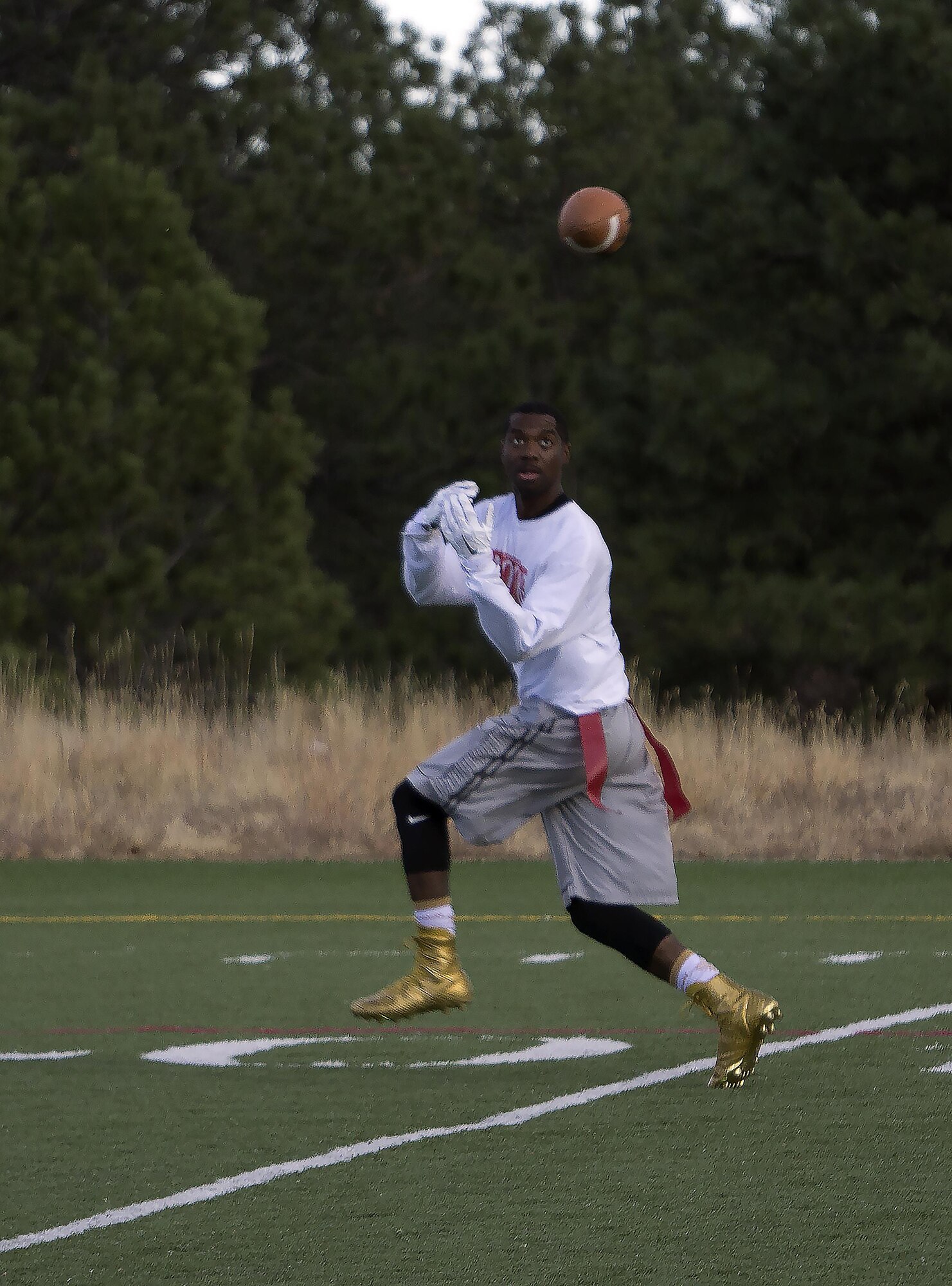Chris Marshall, F.E. Warren Air Force Base, Wyo., intramural flag football team wide receiver, prepares to catch a pass during the Rocky Mountain Intermural Flag Football Tournament at the U.S. Air Force Academy, Colorado Springs, Colo., Oct. 29, 2016. The nine-Airman team played three games, one against each of the other teams in the tournament. Warren won the tournament with a record of two wins and one loss.  (U.S. Air Force photo by Senior Airman Brandon Valle)