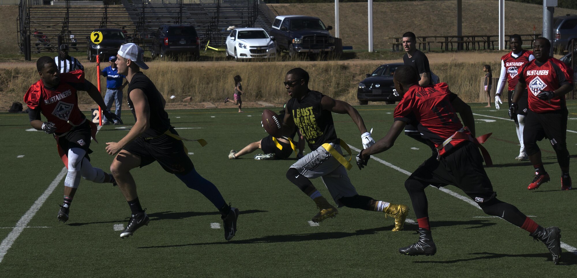 Chris Marshall, F.E. Warren Air Force Base, Wyo., intramural flag football team wide receiver, rushes past a Fort Carson player toward a first down during the Rocky Mountain Intramural Flag Football Tournament at the U.S. Air Force Academy, Colorado Springs, Colo., Oct. 29, 2016. At the end of the game, Warren won 25 to 6. Warren won the tournament with a record of two wins and one loss. (U.S. Air Force photo by Senior Airman Brandon Valle)