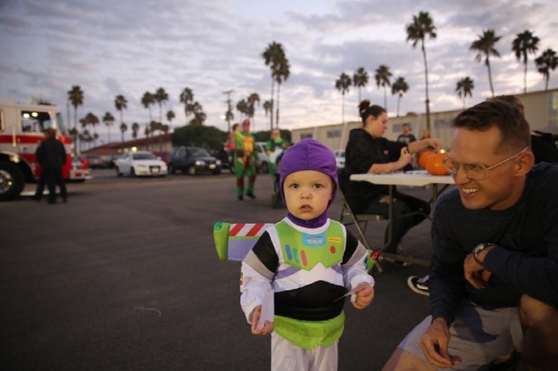 Master Sgt. Scott Dunn, public affairs chief, I Marine Expeditionary Force and his son help celebrate “Trunk or Treat,” at Marine Corps Base Camp Pendleton, Calif., Oct. 28, 2016. The event was hosted by I Marine Expeditionary Force Headquarters Group, and included trick or treating, games, a costume contest, and a free movie showing. (U.S. Marine Corps photo by Pfc. Robert Bliss)