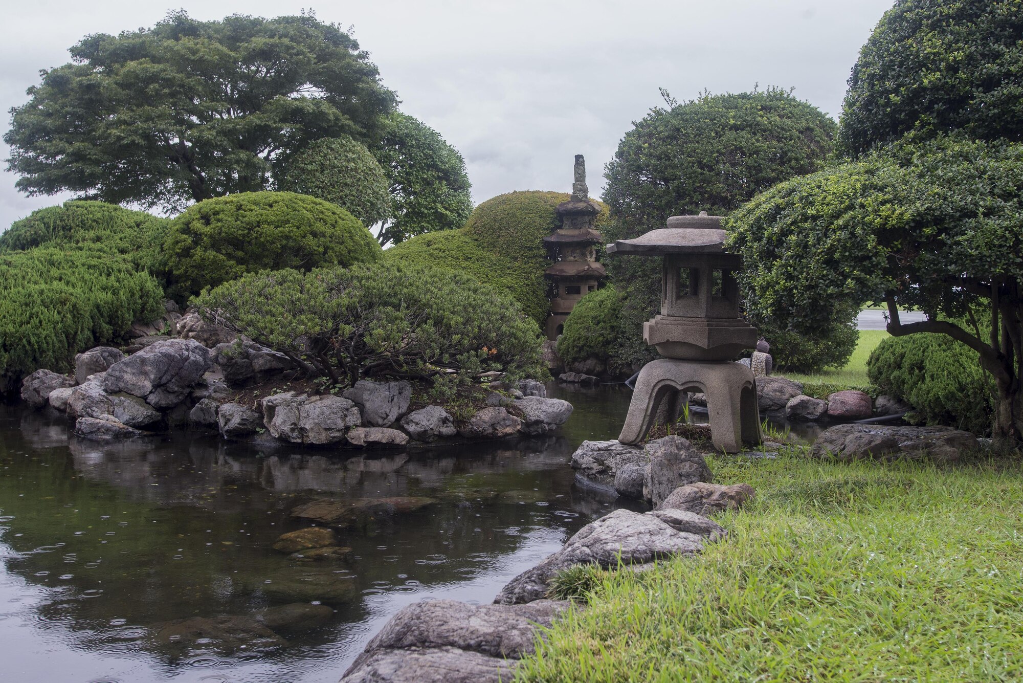 The distinguished visitor garden located between the flightline and 374th Operations Group headquarters at Yokota Air Base, Japan, Aug. 30, 2016. The extended garden was designed by Yoshitaka Yamaguchi and has existed in some form since Yokota was the Tama Army Airfield. The garden hosts multiple monuments including a prisoner-of-war/missing-in-action memorial and the Kofu rock. (U.S. Air Force photo by Senior Airman David C. Danford/Released)