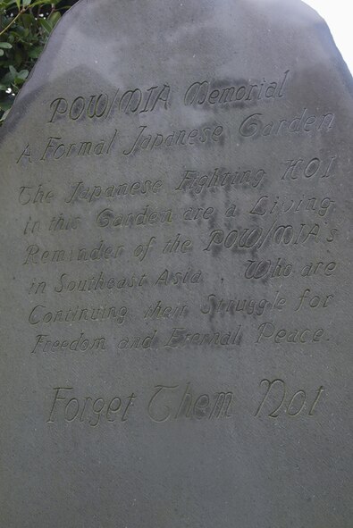 A prisoner-of-war/missing-in-action memorial dedicated to service members lost throughout Southeast Asia is displayed in the distinguished visitor garden at Yokota Air Base, Japan, Aug. 30, 2016. The memorial references the Japanese fighting koi fish found in the nearby pond, comparing their perseverance to the missing service members. In Japanese mythology the koi was recognized by the gods for its determination in swimming up a waterfall and transforming into a dragon. (U.S. Air Force photo by Senior Airman David C. Danford/Released)