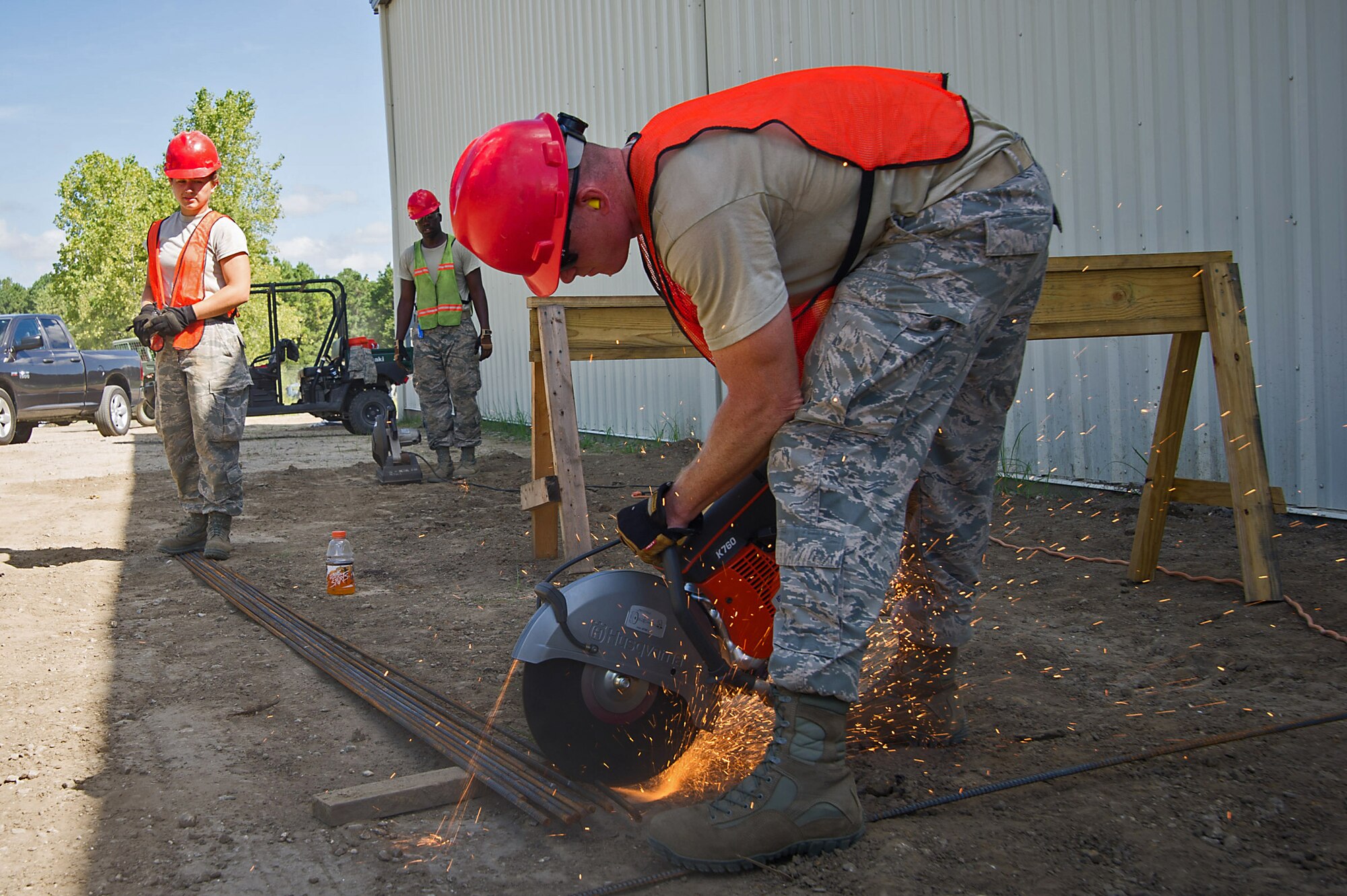 (From left) Senior Airman Naomi Haney, a 560th RED HORSE Squadron structural helper, and Senior Airman Tyler Vann, 560th RHS structural journeyman, cut rebar for use with cement to before laying cement for the apron of a newly constructed 560th RHS building at Joint Base Charleston. In their civilian jobs, Haney is a hopital telemetry technician, and Vann is a firefighter. Members of the 560th RHS and the 628th Civil Engineer Squadron at Joint Base Charleston, Sout Carolina and the 555th RHS from Nellis Air Force Base, Nevada, and the 567th RHS from Seymour Johnson Air Force Base, North Carolina joined forces at Joint Base Charleston to build a 4,800 square-foot preengineered  building building to store construction equipment and gear.  Rapid Engineer Deployable, Heavy Operational Repair Squadron, Engineer (RED HORSE) squadrons provide the Air Force with a highly mobile civil engineering capability in support of contingency and special operations worldwide. They are self-sufficient, mobile squadrons that provide heavy construction support such as runway/facility construction, electrical upgrades, and equipment transport when requirements exceed normal base civil engineer capabilities and where Army engineer support is not readily available. (U.S. Air Force Photo by Master Sgt. Shane Ellis)