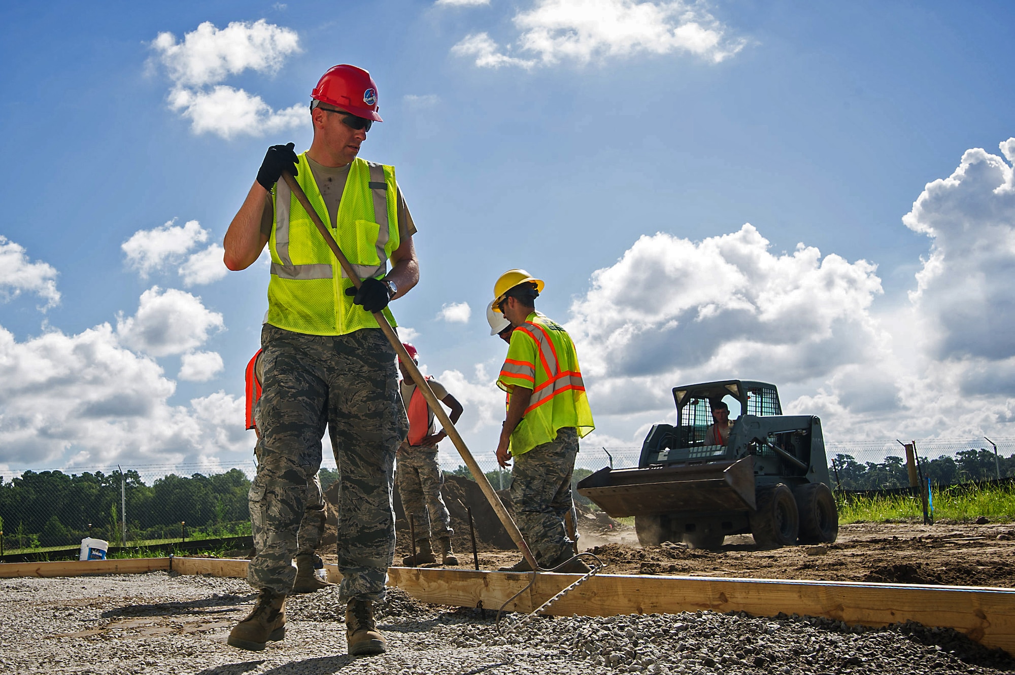 Maj. Matthew Gill, 560th RED HORSE Squadron director of operations, joins his fellow RED HORSE Airmen as they prepare the ground for cement aprons outside the new building they are constructing at Joint Base Charleston. Members of the 560th RHS and the 628th Civil Engineer Squadron at Joint Base Charleston, Sout Carolina and the 555th RHS from Nellis Air Force Base, Nevada, and the 567th RHS from Seymour Johnson Air Force Base, North Carolina joined forces at Joint Base Charleston to build a 4,800 square-foot preengineered  building building to store construction equipment and gear.  Rapid Engineer Deployable, Heavy Operational Repair Squadron, Engineer (RED HORSE) squadrons provide the Air Force with a highly mobile civil engineering capability in support of contingency and special operations worldwide. They are self-sufficient, mobile squadrons that provide heavy construction support such as runway/facility construction, electrical upgrades, and equipment transport when requirements exceed normal base civil engineer capabilities and where Army engineer support is not readily available. (U.S. Air Force Photo by Master Sgt. Shane Ellis)