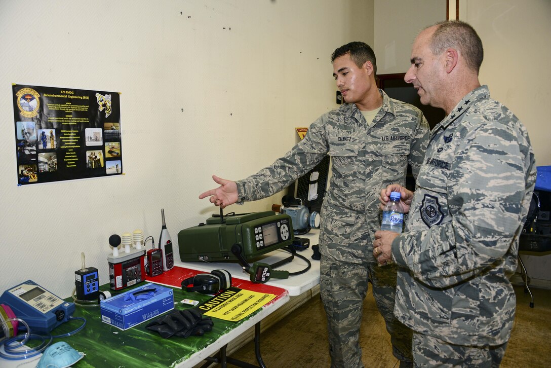 Senior Airman Samuel Chavez, 379th Expeditionary Medical Operations Squadron bioenvironmental engineering technician, shows Lt. Gen. Jeffrey L. Harrigian, U.S. Air Forces Central Command commander, bioenvironmental equipment used for occupational health surveillance and response equipment used in emergencies during a 379th Air Expeditionary Wing tour Aug. 11, 2016, at Al Udeid Air Base, Qatar. The tour included stops at the 379th Expeditionary Medical Group, Bioenvironmental Flight, Intra-Theater Care Program, Mental Health, a Cadillac in the process of renovation and the Doublestacks living complex. (U.S. Air Force photo/Senior Airman Janelle Patiño/Released)