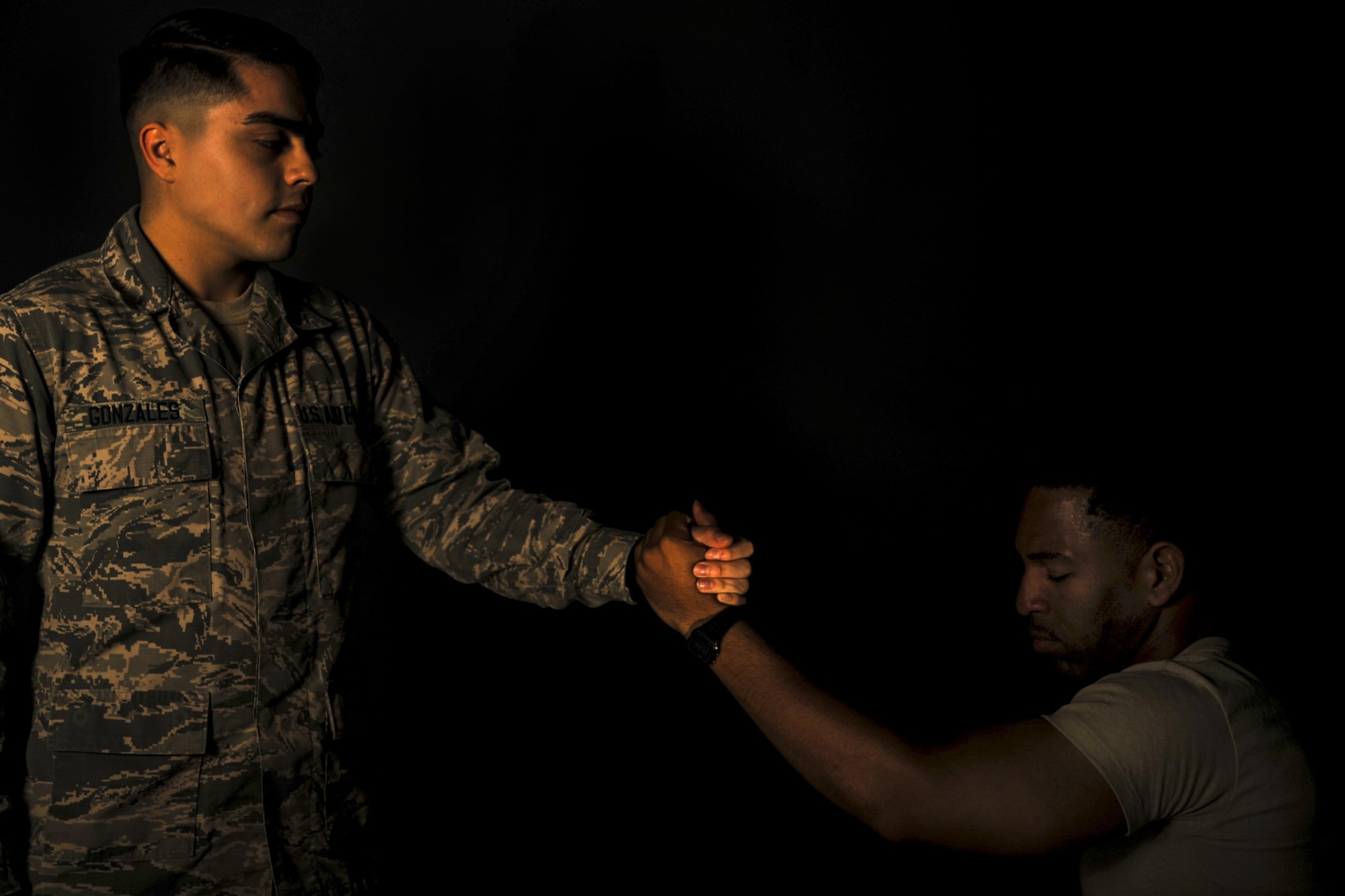 U.S. Air Force Airman Cassidy Gonzales, 23d Medical Operations Squadron mental health technician, grips the hand of Airman Giancarlo Carter, 23d Wing broadcast journalist apprentice, Aug. 31, 2016, at Moody Air Force Base, Ga. Since September is National Suicide Prevention Awareness Month, Air Force leadership takes this time to remind Airmen about the power of wingmanship and emphasize the resources available to combat hard times. (U.S. Air Force photo by Airman 1st Class Daniel Snider)