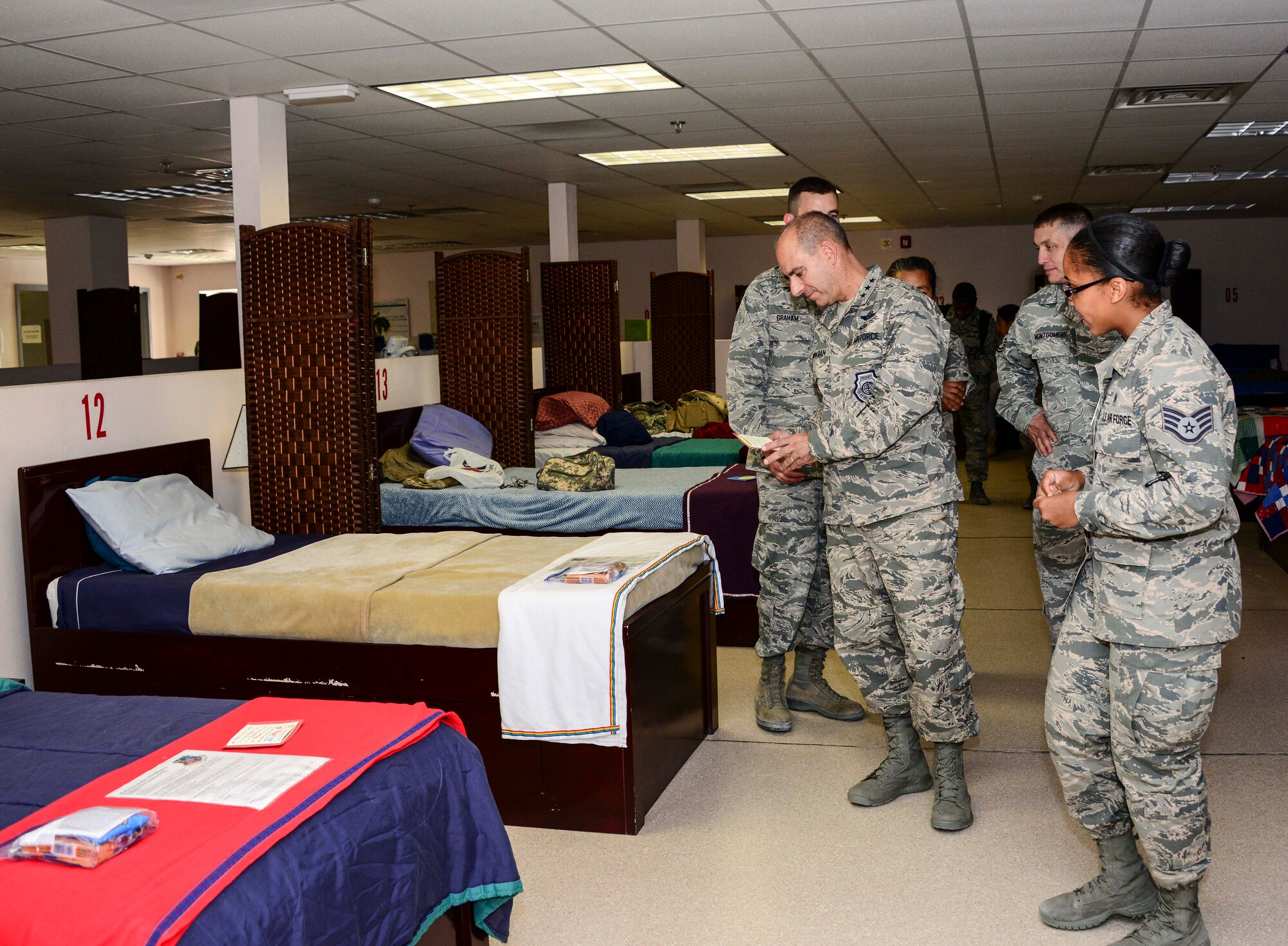 Lt. Gen. Jeffrey L. Harrigian, U.S. Air Forces Central Command commander reads a letter as he tours the Enroute Patient Staging Facility Aug. 11, 2016, at Al Udeid Air Base, Qatar. Harrigian along with Chief Master Sgt. Joseph Montgomery, USAFCENT command chief, visited various facilities to experience what the base offers to accomplish the mission. (U.S. Air Force photo/Senior Airman Janelle Patiño/Released)