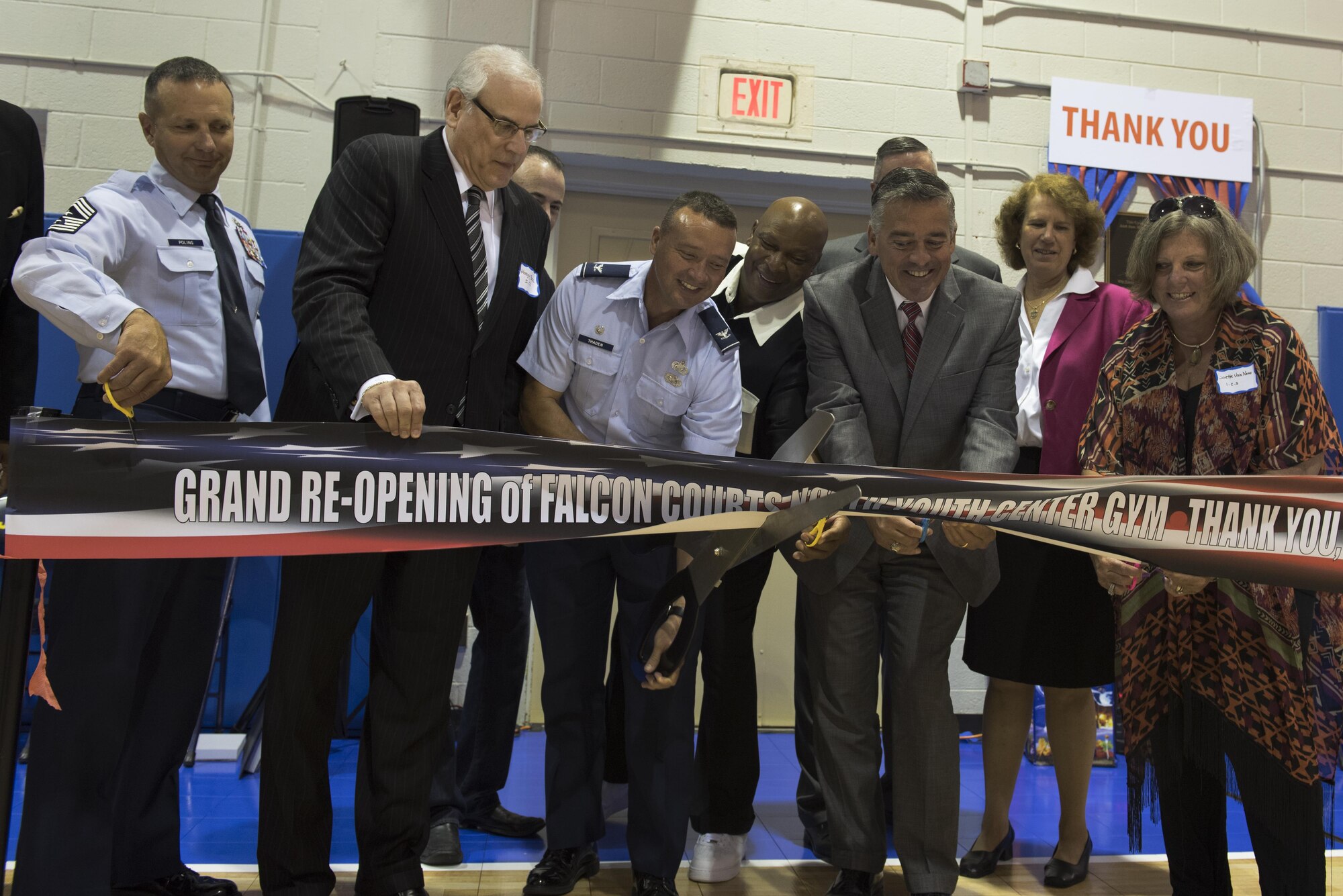 Col. Frederick D. Thaden, Chief Master Sgt. Craig Poling and donors and guests including former NBA player, World B. Free, cut the ribbon at the new Falcon Courts Youth Center Gym on Joint Base McGuire-Dix-Lakehurst, N.J., Aug. 31, 2016. Thaden is the JB MDL and 87th Air Base Wing commander and Poling is the 87th ABW command chief.

