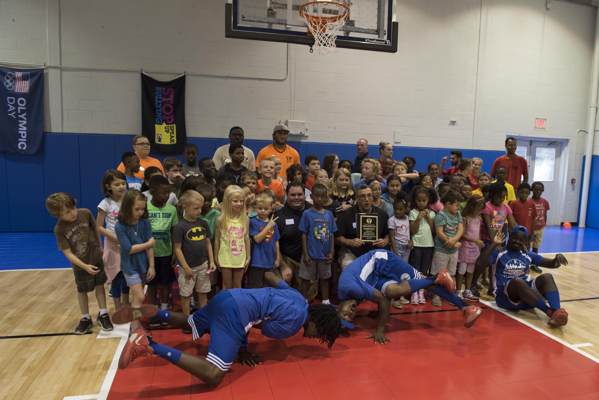 The Philadelphia 76ers’ trick shot team, Phlight Squad, helped the children of military families break in the new Falcon Courts Youth Center Gym with a youth basketball clinic on Joint Base McGuire-Dix-Lakehurst, N.J., Aug. 31, 2016. The event helped the children improve their skills and knowledge of the sport.
