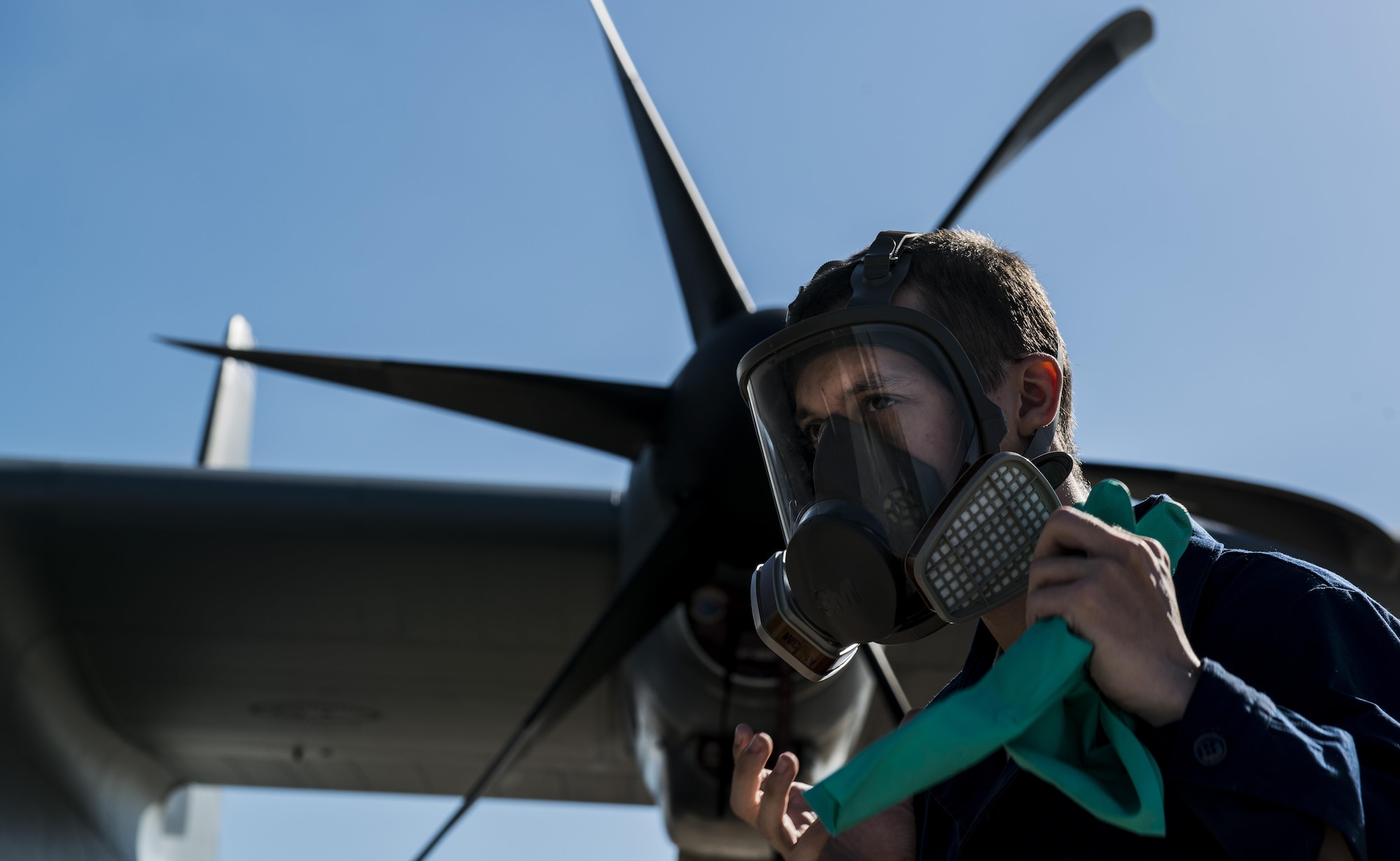 Airman 1st Class Christopher Jones, 786th Civil Engineer Squadron pest management specialist, dons gloves before spraying Callington Pre-Spray in a C-130J Super Hercules to prevent the spread of the zika virus Aug. 29, 2016 at Ramstein Air Base, Germany. Once the plane has been sprayed, it is closed for 30 minutes to allow the pre-spray to settle, then opened to air out for an additional 30 minutes. (U.S. Air Force photo/Senior Airman Tryphena Mayhugh)