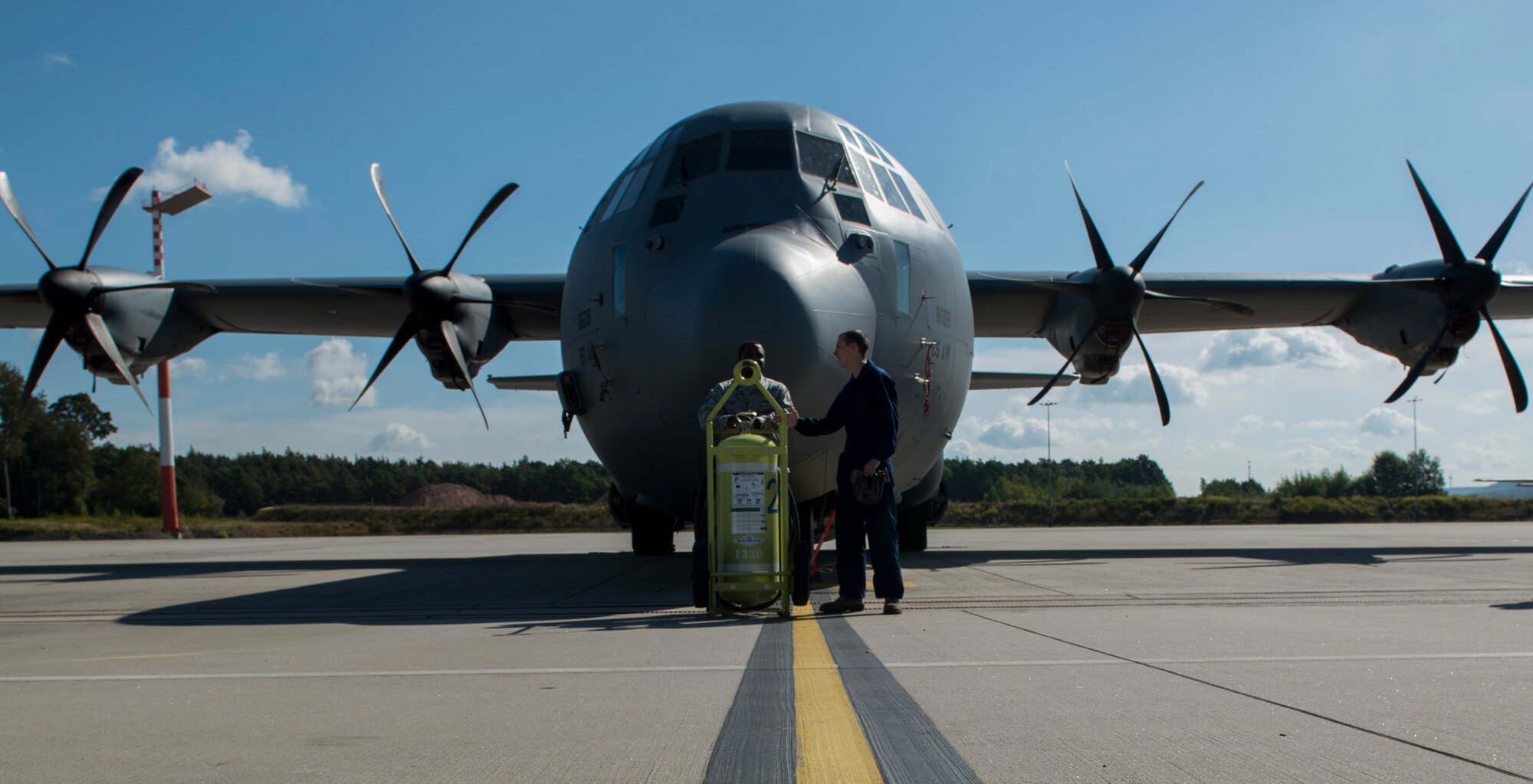 Staff Sgt. Antonio Gross and Airman 1st Class Christopher Jones, 786th Civil Engineer Squadron pest management specialists, wait for the Callington Pre-Spray to settle inside a C-130J Super Hercules to prevent the spread of the zika virus Aug. 29, 2016 at Ramstein Air Base, Germany. After the pre-spray has settled for 30 minutes, the aircraft is aired out for an additional 30 minutes. (U.S. Air Force photo/Senior Airman Tryphena Mayhugh)