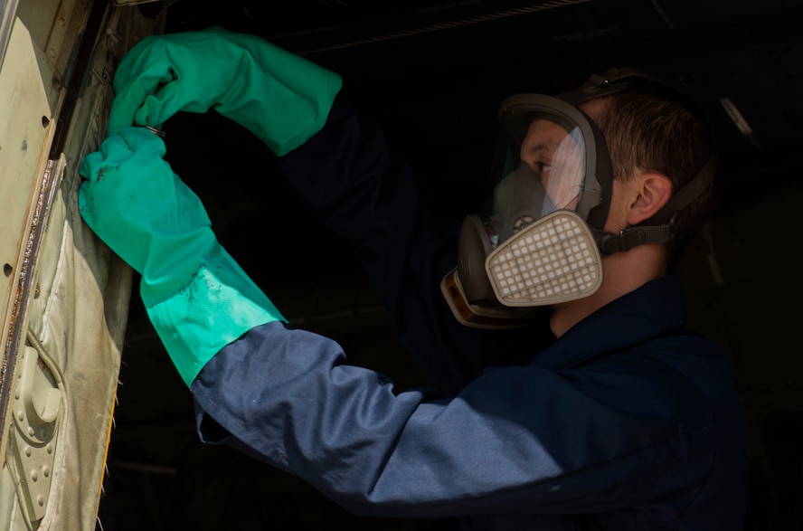 Airman 1st Class Christopher Jones, 786th Civil Engineer Squadron pest management specialist, opens the door of a C-130J Super Hercules Aug. 29, 2016 at Ramstein Air Base, Germany. Jones had closed the aircraft for 30 minutes after spraying Callington Pre-Spray inside to prevent the spread of the zika virus. (U.S. Air Force photo/Senior Airman Tryphena Mayhugh)