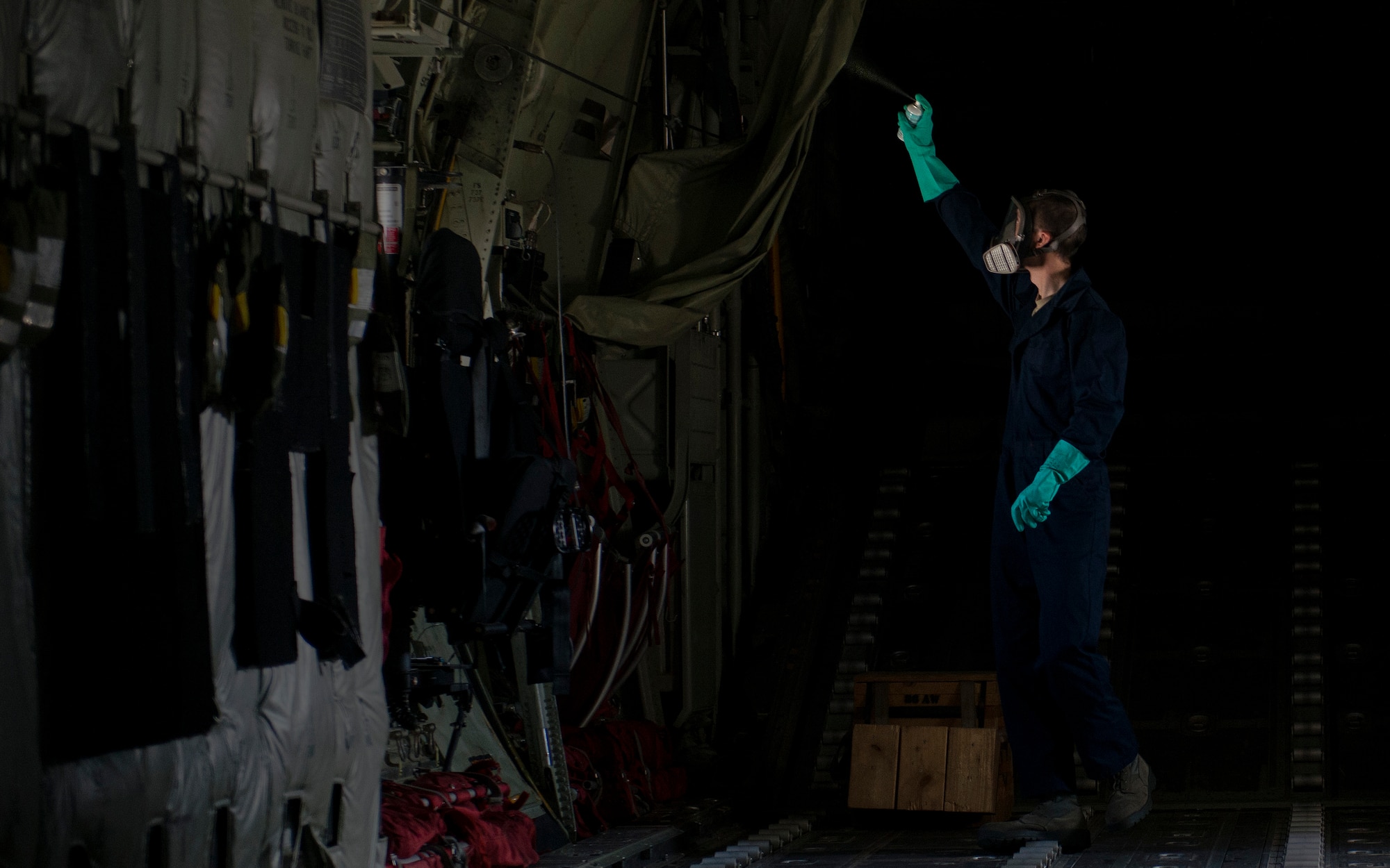 Airman 1st Class Christopher Jones, 786th Civil Engineer Squadron pest management specialist, sprays Callington Pre-Spray in a C-130J Super Hercules to prevent the spread of the zika virus Aug. 29, 2016 at Ramstein Air Base, Germany. The pre-spray prevents the spread of the virus by leaving behind a residue that kills mosquitos and other flying insects on contact. (U.S. Air Force photo/Senior Airman Tryphena Mayhugh)