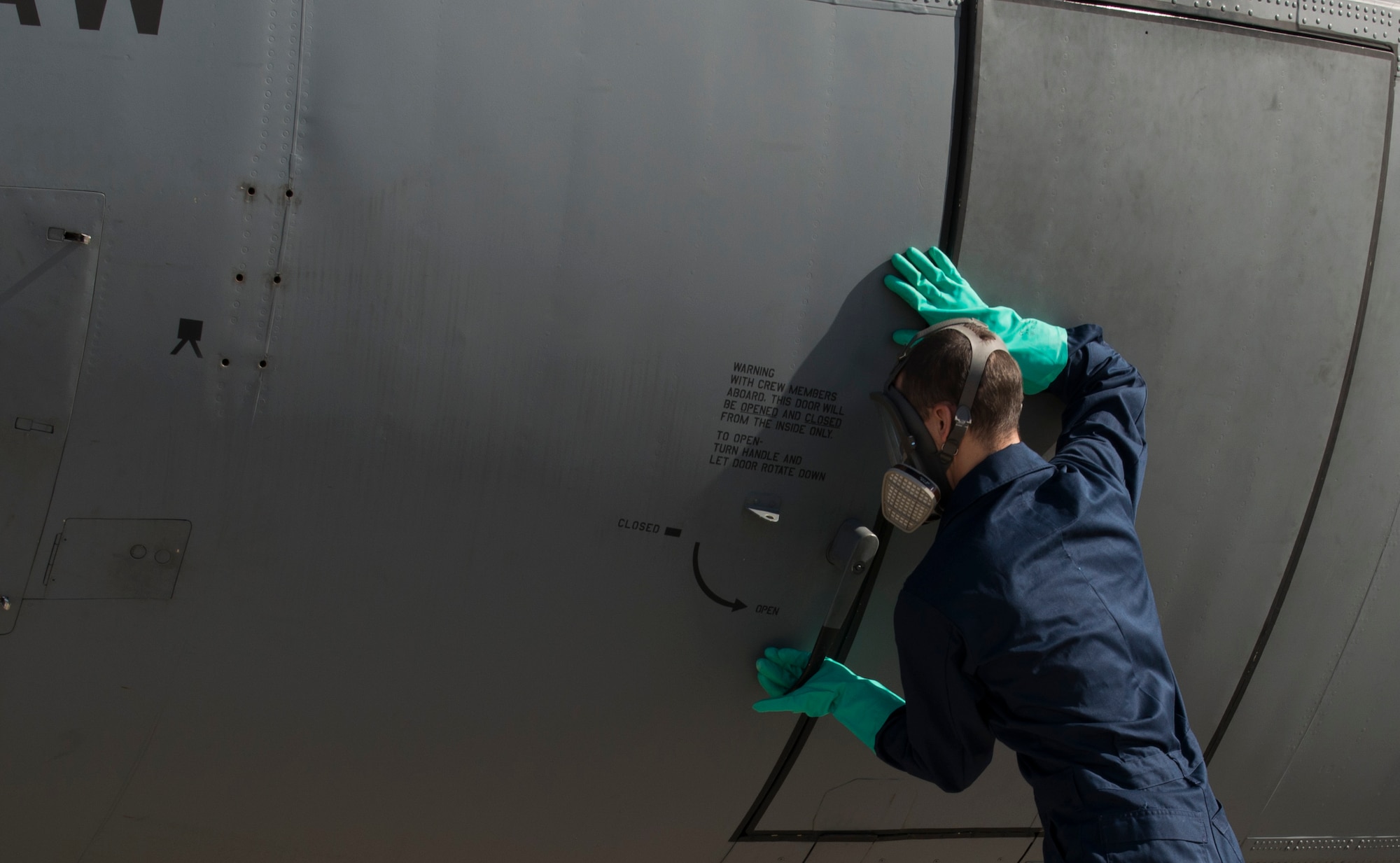 Airman 1st Class Christopher Jones, 786th Civil Engineer Squadron pest management specialist, closes the door of a C-130J Super Hercules after spraying the inside with Callington Pre-Spray to prevent the spread of the zika virus Aug. 29, 2016 at Ramstein Air Base, Germany. Jones closed the aircraft to allow the pre-spray to settle for 30 minutes. (U.S. Air Force photo/Senior Airman Tryphena Mayhugh)