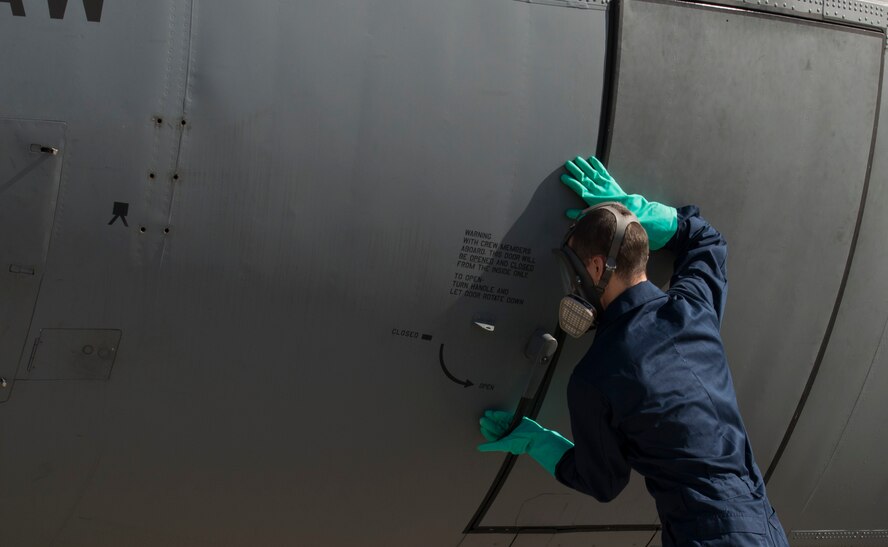 Airman 1st Class Christopher Jones, 786th Civil Engineer Squadron pest management specialist, closes the door of a C-130J Super Hercules after spraying the inside with Callington Pre-Spray to prevent the spread of the zika virus Aug. 29, 2016 at Ramstein Air Base, Germany. Jones closed the aircraft to allow the pre-spray to settle for 30 minutes. (U.S. Air Force photo/Senior Airman Tryphena Mayhugh)