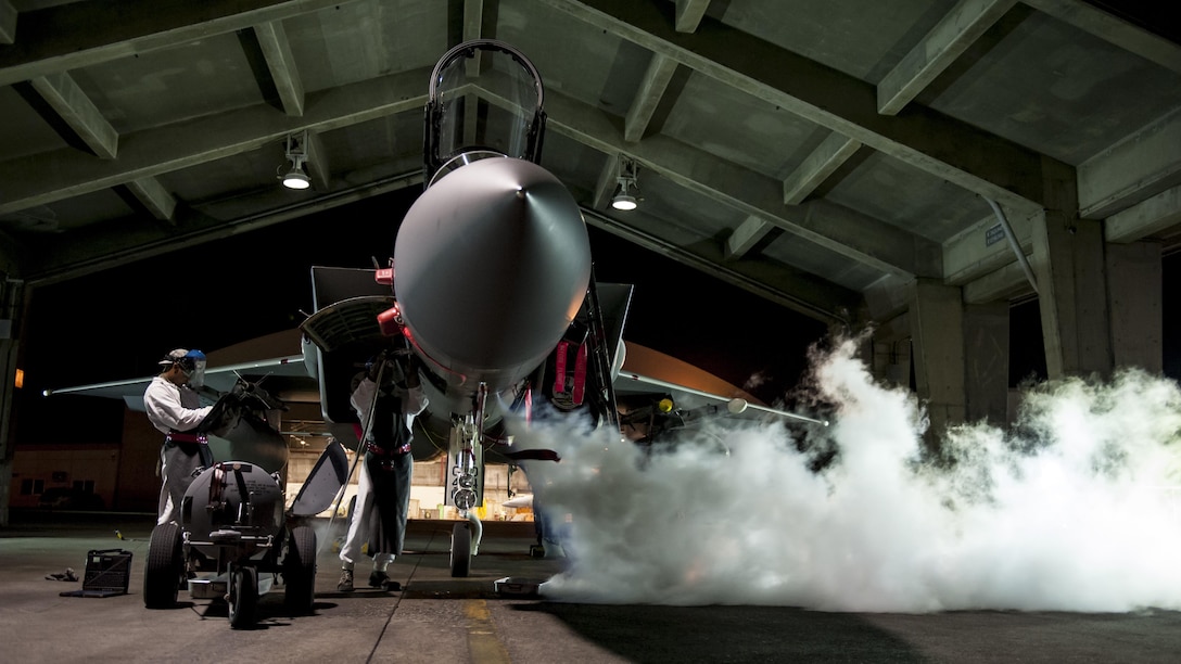Airman Marquel Marshall and Airman 1st Class Darris Little, both 67th Aircraft Maintenance Unit F-15 Eagle crew chiefs, service a liquid oxygen converter on the flightline Aug. 24, 2016, at Kadena Air Base, Japan. Marshal and Little work as swing shift maintainers, ensuring around-the-clock mission readiness of Kadena AB’s F-15s. (U.S. Air Force photo/Senior Airman Peter Reft)