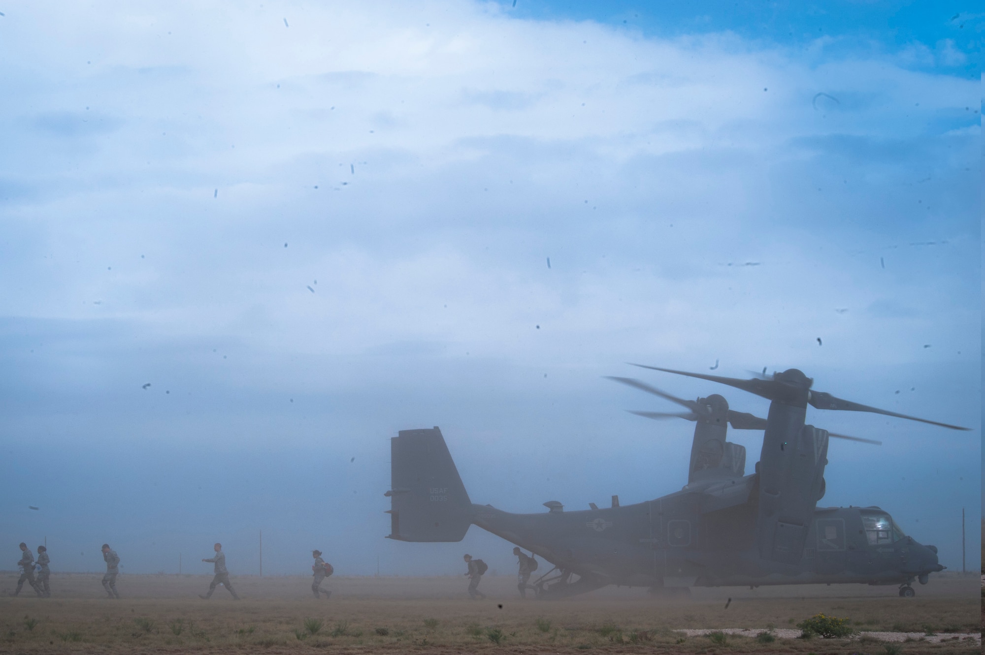 Emergency medical technicians participating in the 2016 EMT Rodeo exit a CV-22 Osprey at Melrose Air Force Range, N.M., Aug. 25, 2016. Cannon Air Force Base’s EMT Rodeo tests the skills of medical professionals from across the Air Force through a series of innovative, high-pressure scenarios. (U.S. Air Force photo/Tech. Sgt. Manuel J. Martinez)