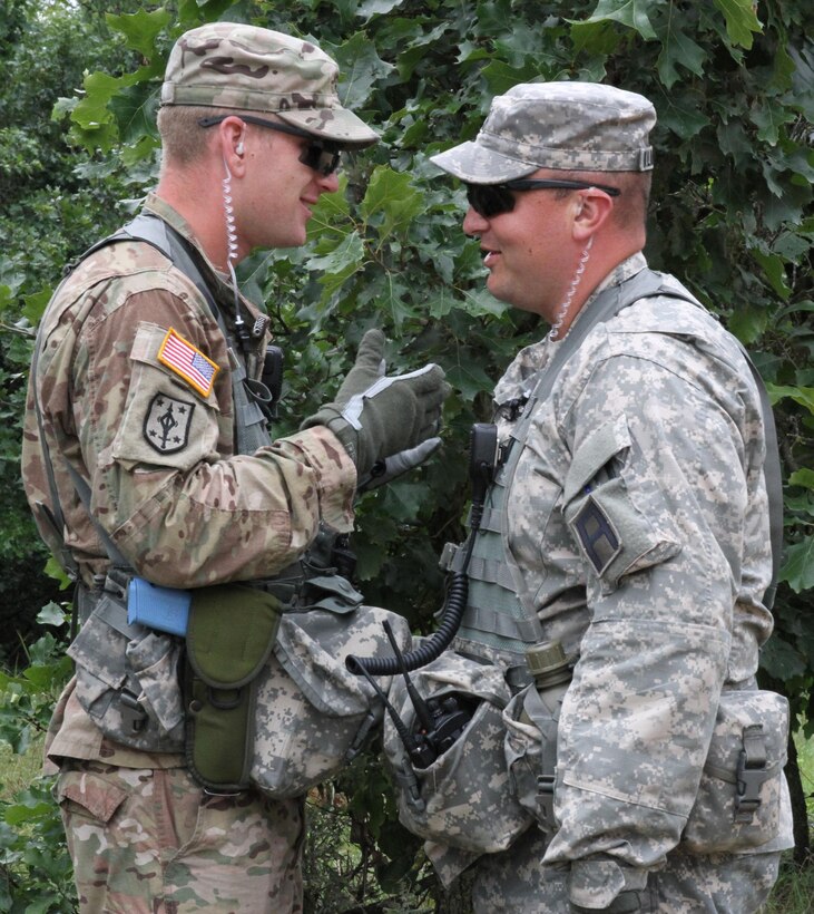 FORT MCCOY, Wis. - Observer, controller, trainers with 181st Infantry Brigade, discuss observations they've made of the U.S. Army Reserve's 301st Military Police Company Aug. 20 during Combat Support Training Exercise 86-16-03 at Fort McCoy, Wis. (U.S. Army Reserve photo by Staff Sgt. Debralee Best)