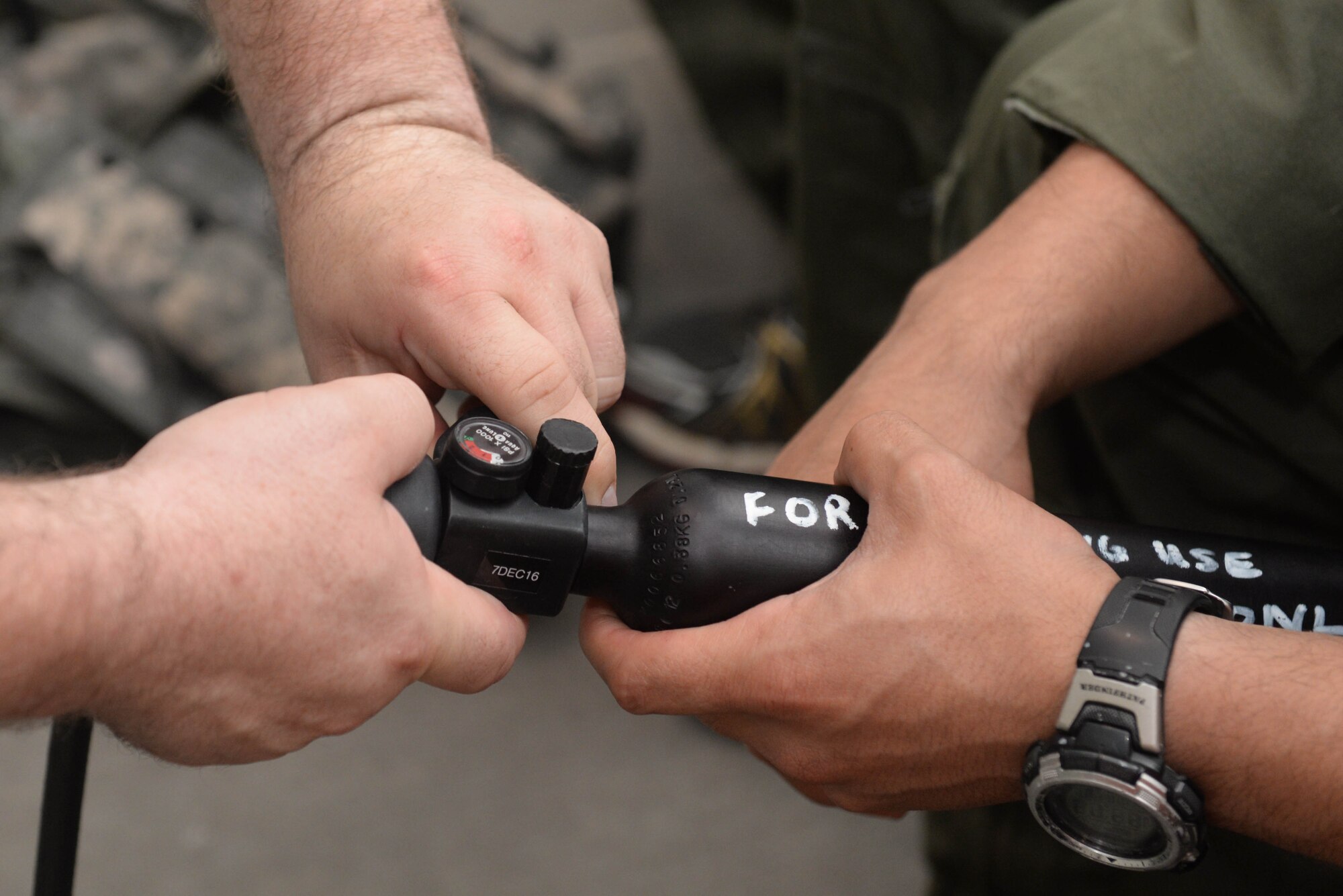 An Airman from the 54th Helicopter Squadron is briefed on pre-training safety precautions during survival, evasion, resistance and escape   egress training at the McAdoo Fitness Center at Minot Air Force Base, N.D., Aug. 31, 2016. This tube of air contains approximately 15 breaths for underwater survival training. (U.S. Air Force photo/Airman 1st Class Jessica Weissman)