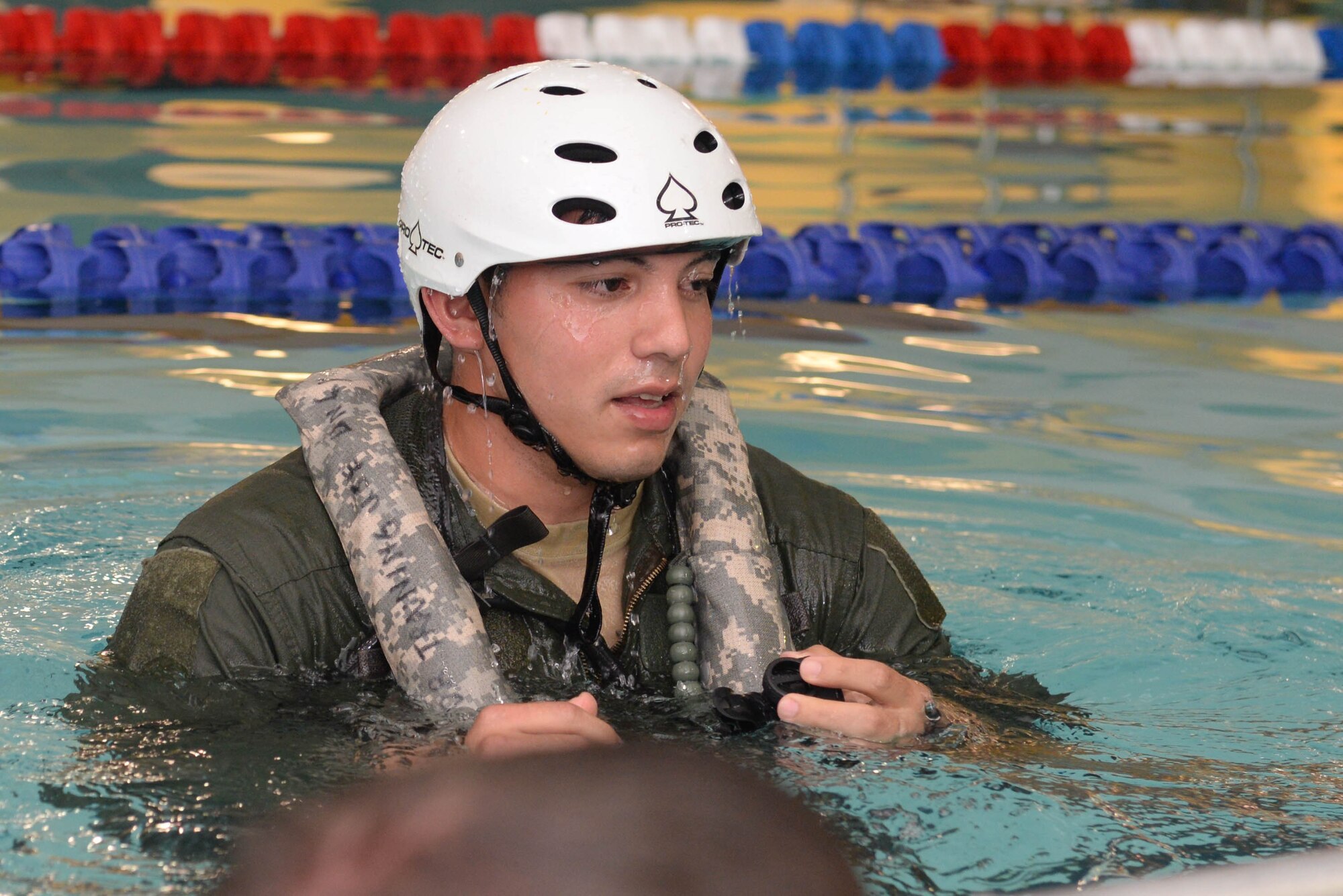 Staff Sgt. Manuel Salazar, a flight engineer assigned to the 54th Helicopter Squadron, emerges from the water during survival, evasion, resistance and escape  egress training at the McAdoo Fitness Center at Minot Air Force Base, N.D., Aug. 31, 2016. Underwater egress training prepares Airmen for escape during a potential crash into water. (U.S. Air Force photo/Airman 1st Class Jessica Weissman)