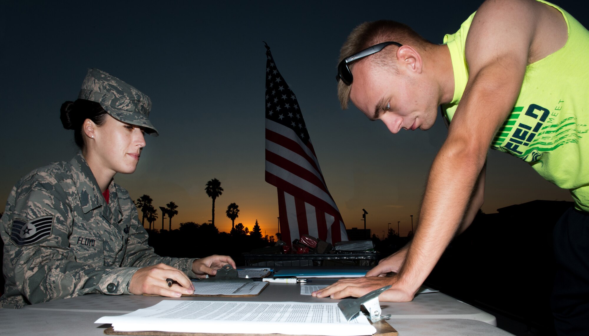U.S. Air Force Tech. Sgt Natalie Floyd, NCOIC operations, 60th Force Support Squadron, Travis Air Force Base, Calif., checks in Senior Airman Alex Robinson, 60th Aerial Port Squadron for the GORUCK Light training at Travis Air Force Base, Calif., Aug. 26. GORUCK Light is a snapshot of the type of training that Special Operations Forces participate in and all proceeds benefit the Green Beret Foundation. (U.S. Air Force photo by Louis Briscese)