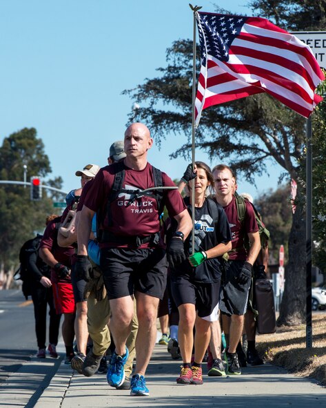 Participants of the GORUCK Light training at Travis Air Force Base, Calif., endure through a 6-mile march, Aug. 26, 2016. GORUCK Light is a snapshot of the type of training that Special Operations Forces participate in and all proceeds benefit the Green Beret Foundation. (U.S. Air Force photo by Louis Briscese)