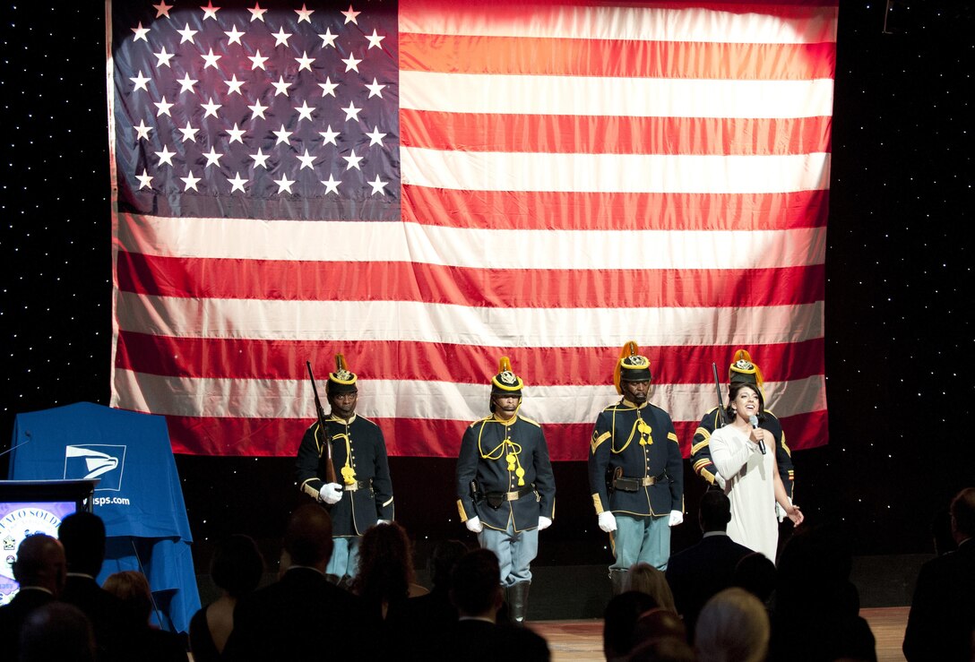 Marine Veteran Rachel Bartlett sings the national anthem while reenactors from the Buffalo Soldiers Mounted Cavalry Unit present the colors at the opening of the Black Chamber of Orange County’s Annual Banquet at the Disneyland Hotel August 27, 2016, in Anaheim, Calif. The banquet, held annually, highlights a black history theme each year. This year’s theme was the legacy of Buffalo Soldiers, or Soldiers who served in segregated African-American units from 1866-1954. (U.S. Army photo by Sgt. 1st Class Alexandra Hays, 79th Sustainment Support Command).